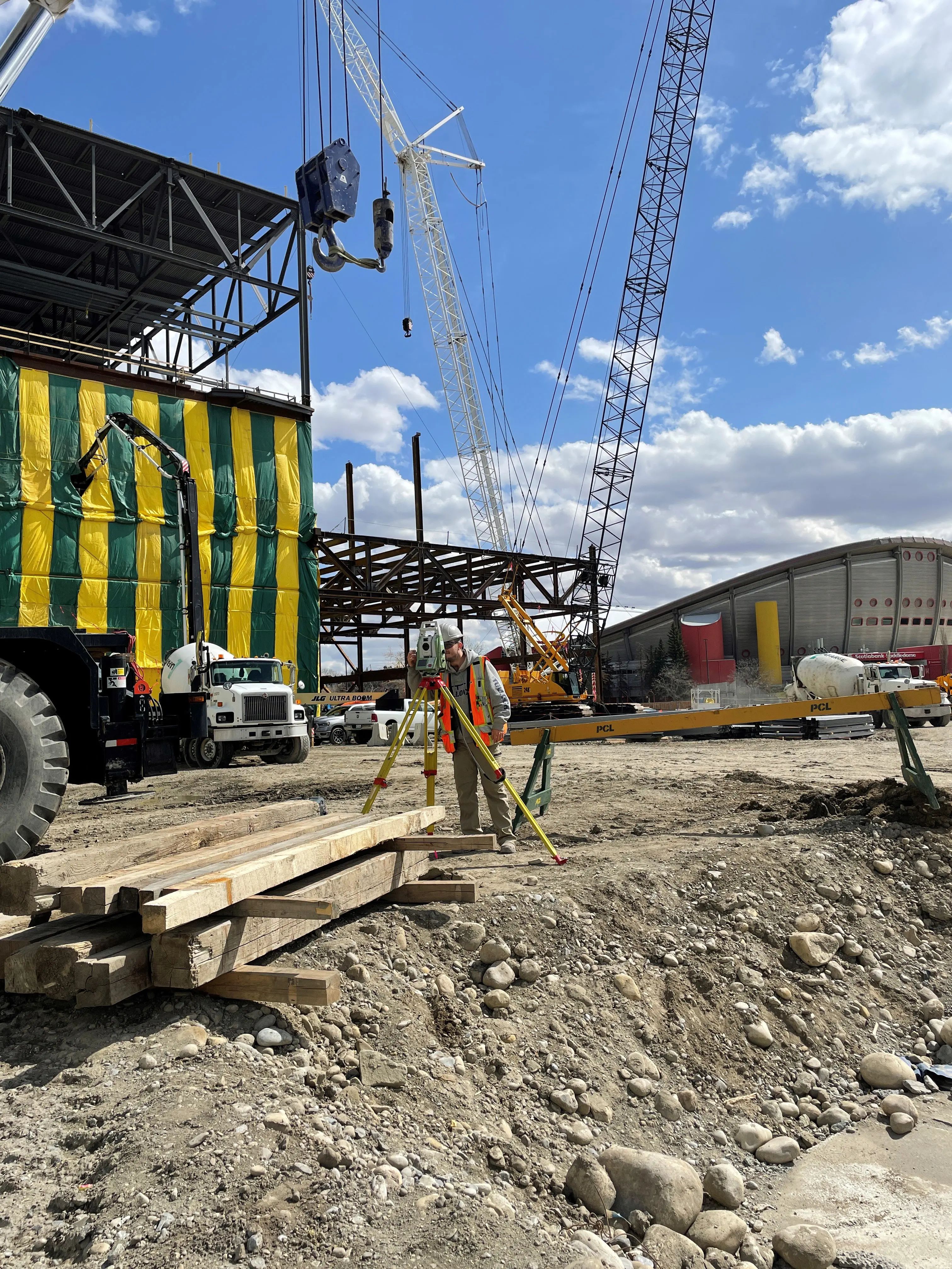 TULLOCH survey equipment set up beside crane and construction activity.