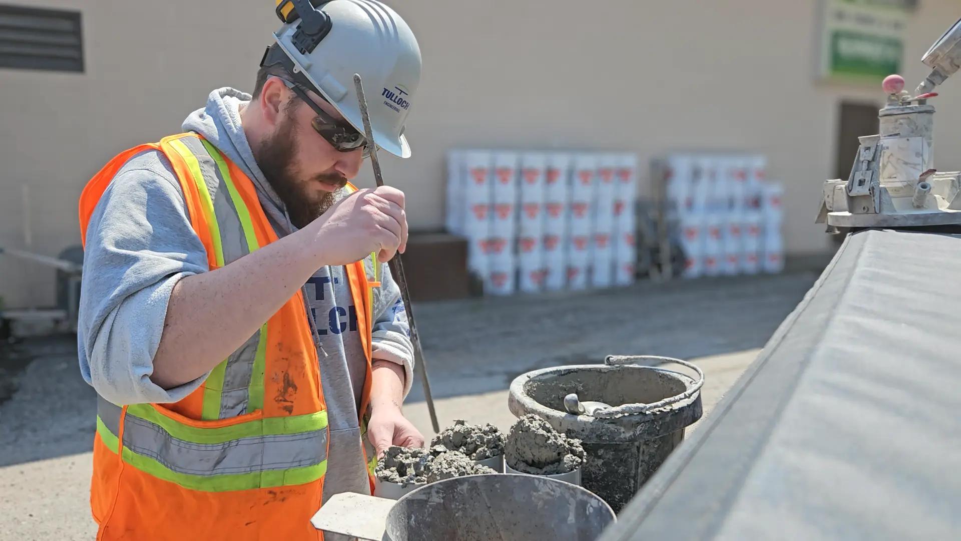 TULLOCH field technician preparing or testing a concrete sample.