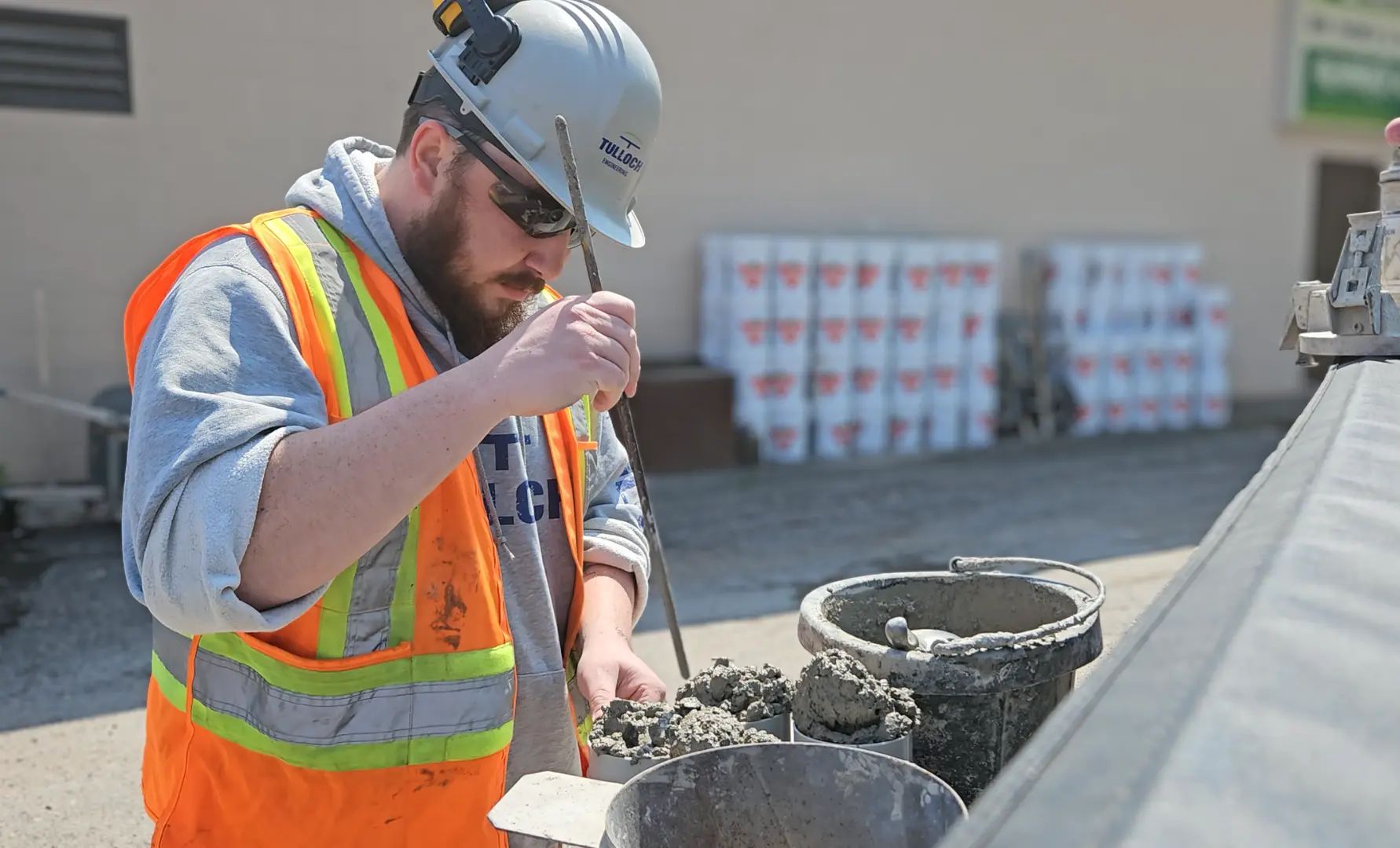 TULLOCH field technician preparing or testing a concrete sample.