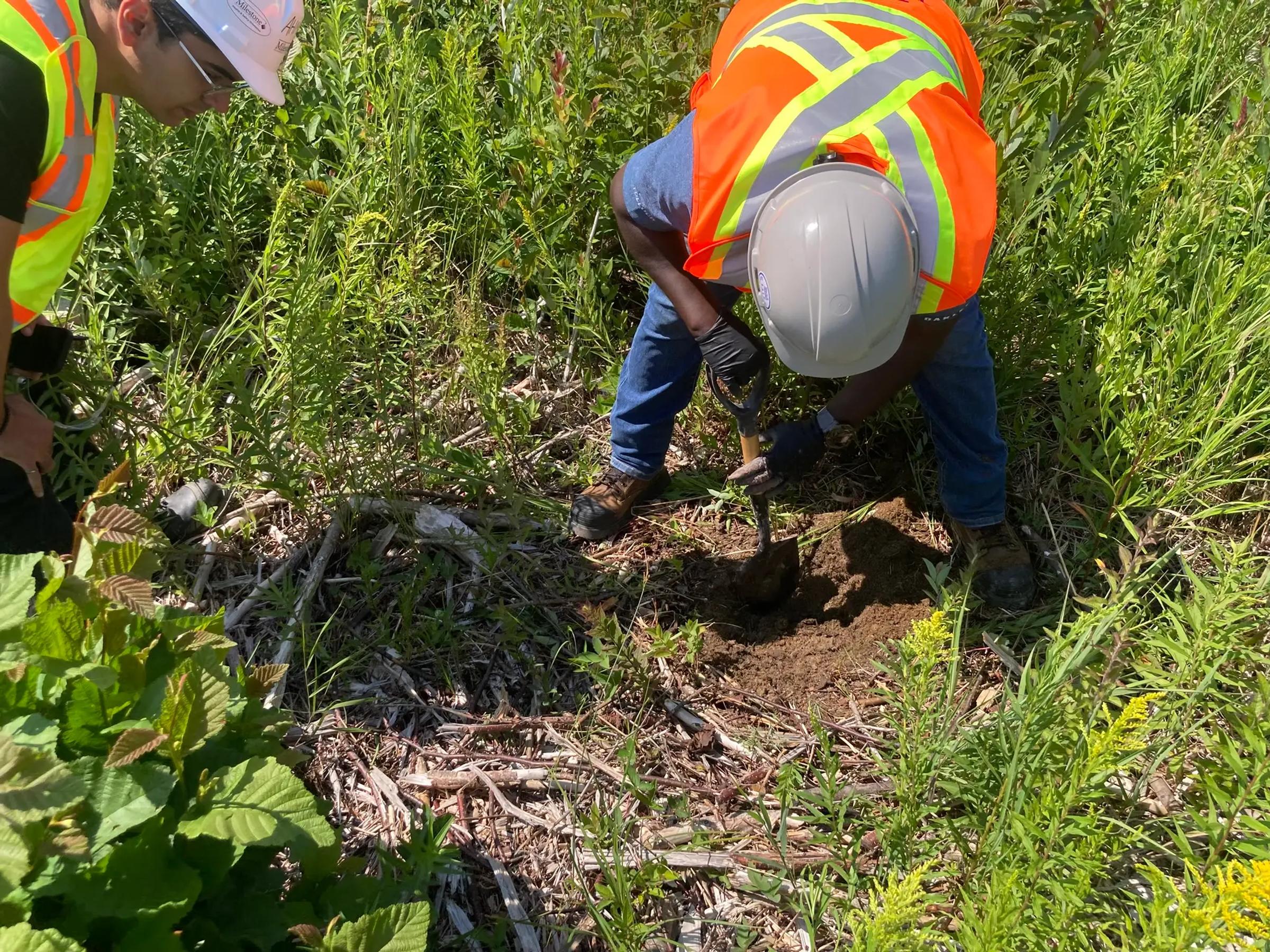 Environmental field technician collecting soil samples during remediation work at Serpent River First Nation.