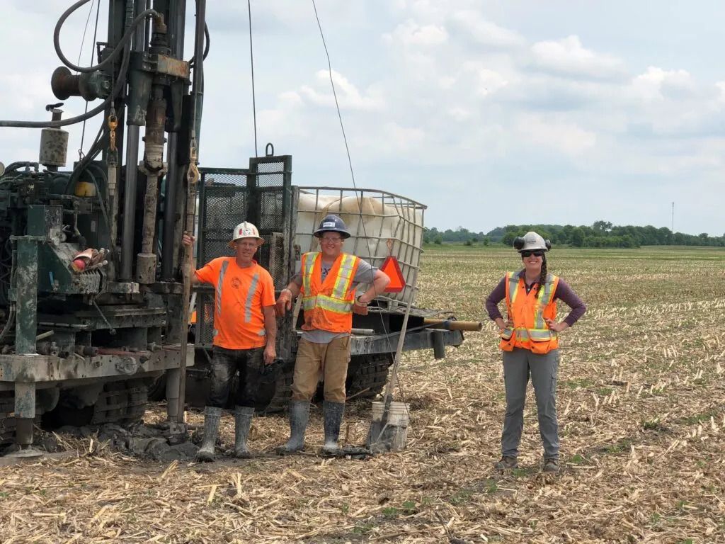 Geotechnical field crew working beside drilling equipment at the Nation Rise Wind project.
