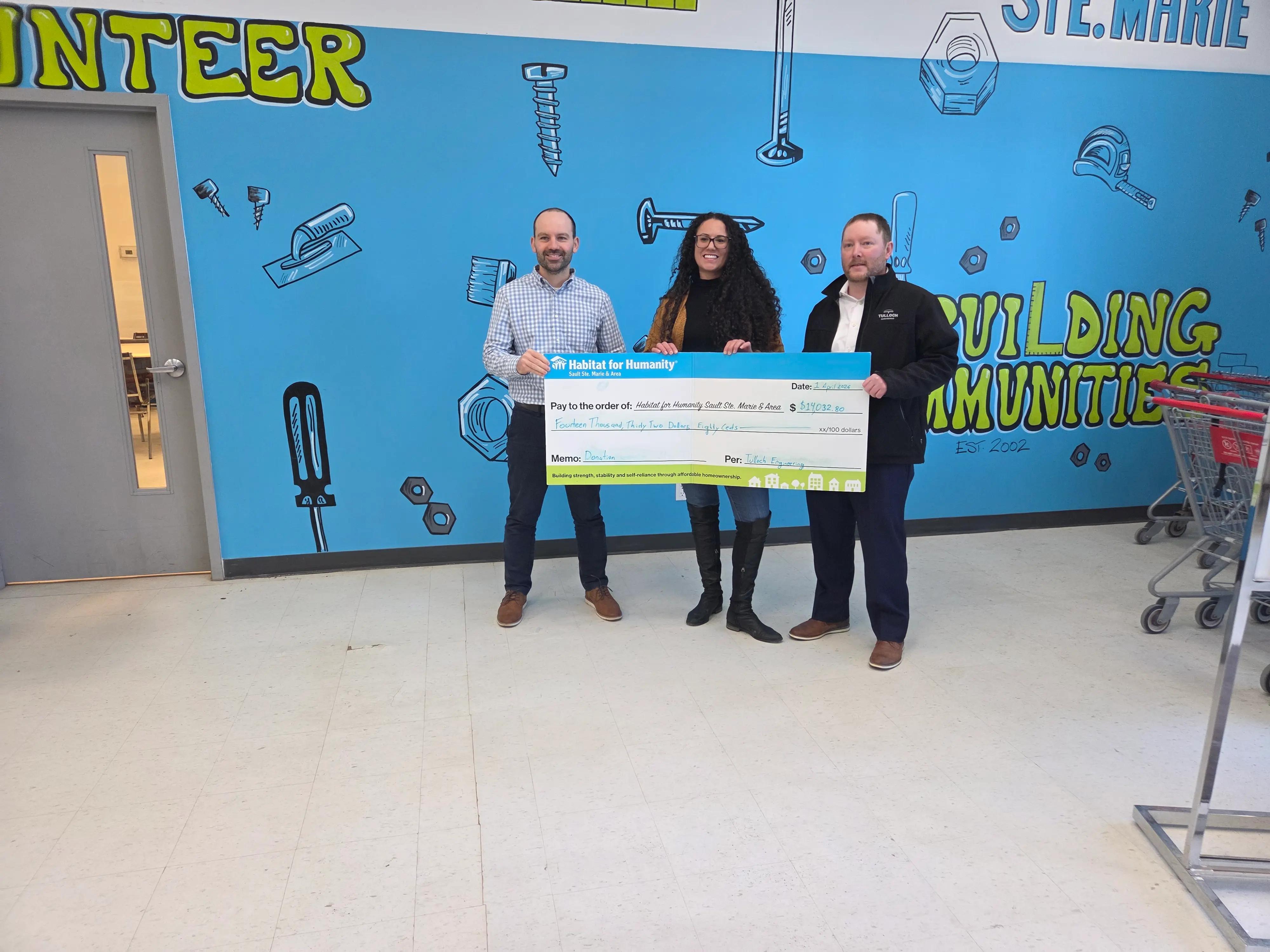 Team TULLOCH with Habitat for Humanity cheque during donation.