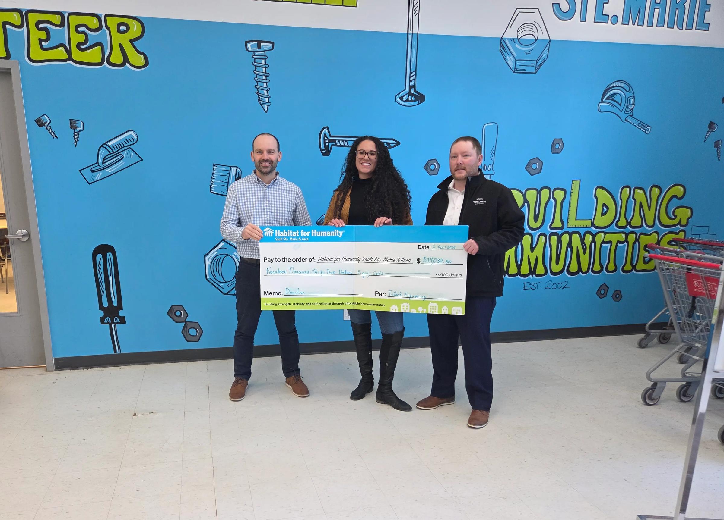 Team TULLOCH with Habitat for Humanity cheque during donation.