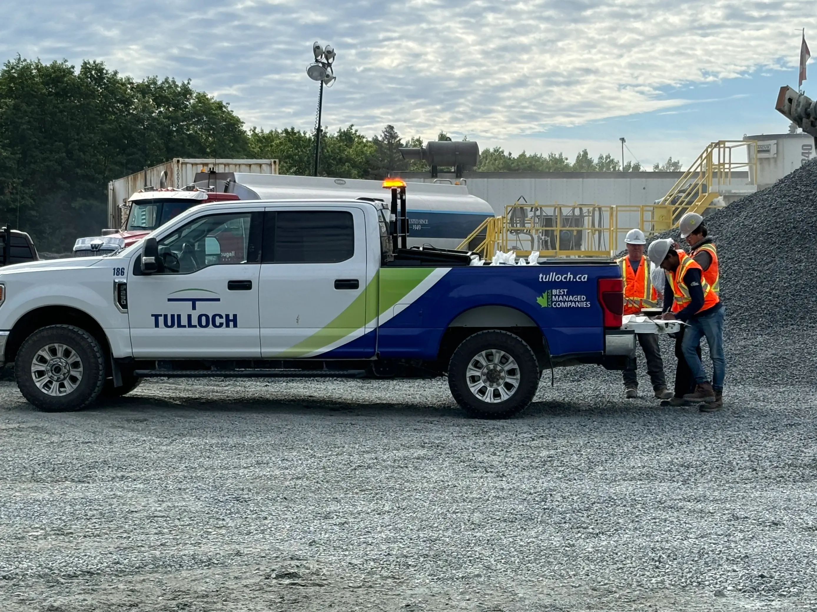 TULLOCH team onsite reviewing drawings on tailgate.