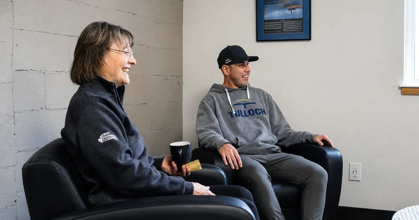 TULLOCH Enterprises staff members seated together in an office.