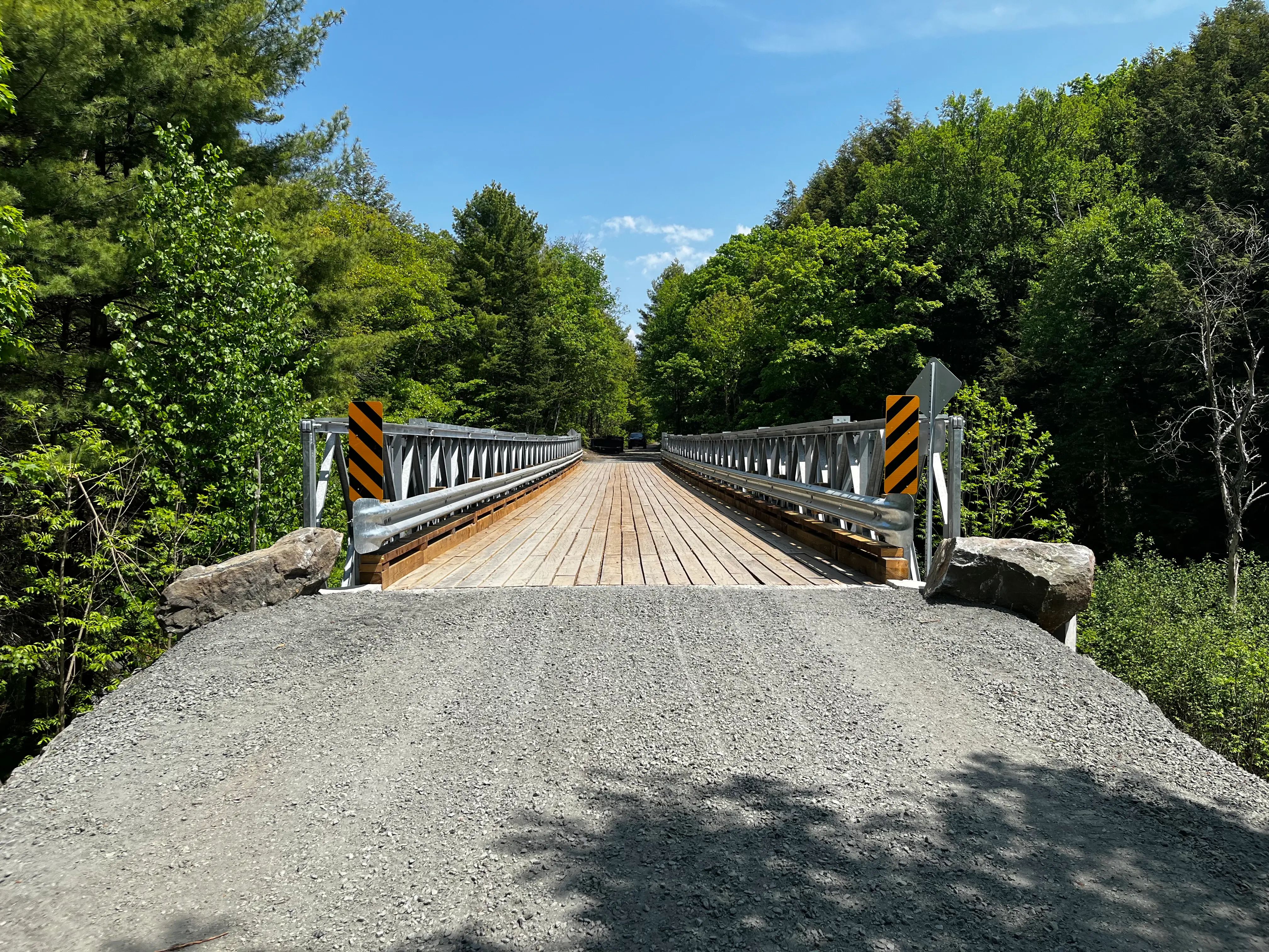 Completed Seguin Bridge 27 replacement on a gravel road in a forested setting.