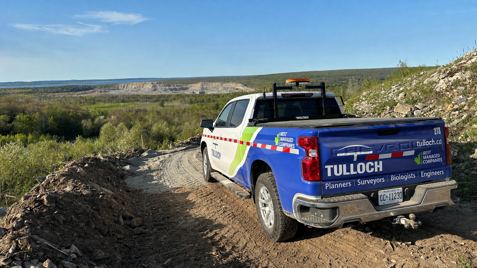 TULLOCH company truck parked along a remote industrial or mine access road.