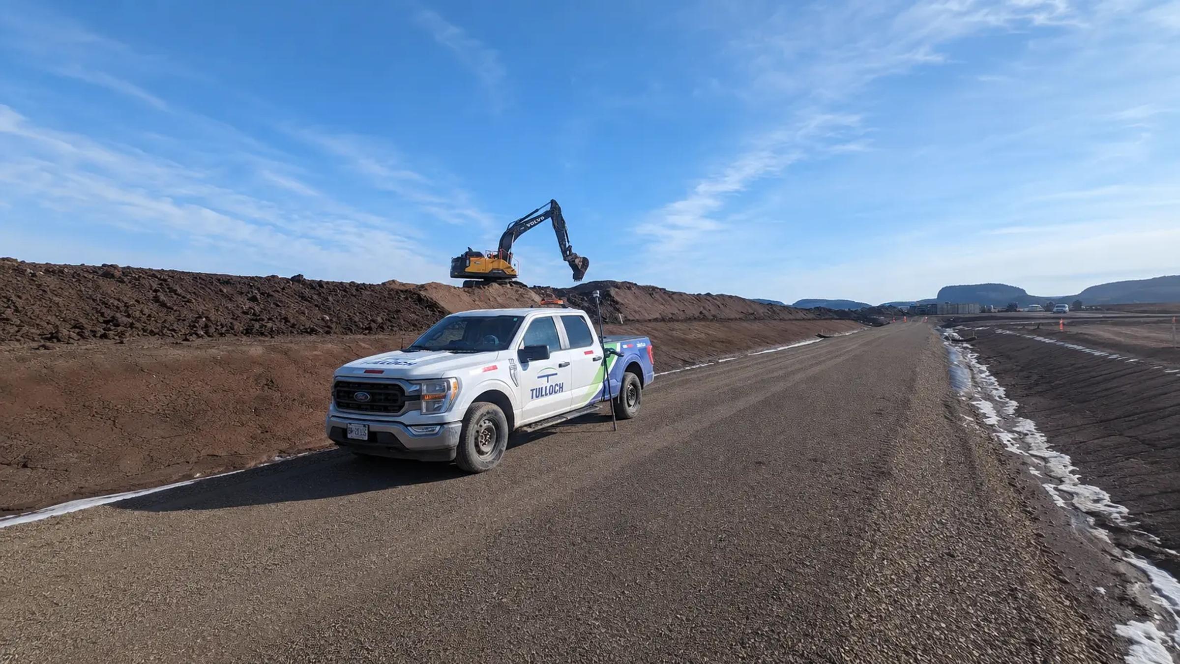 TULLOCH company truck travelling on an active mine or earthworks road.