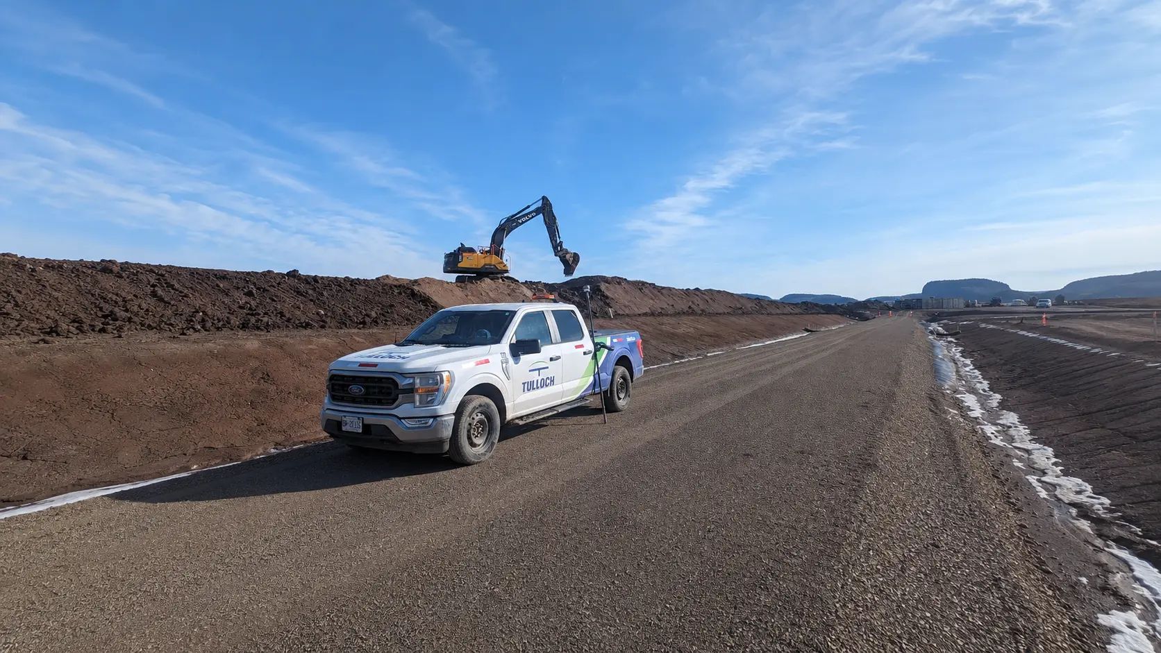 TULLOCH company truck travelling on an active mine or earthworks road.