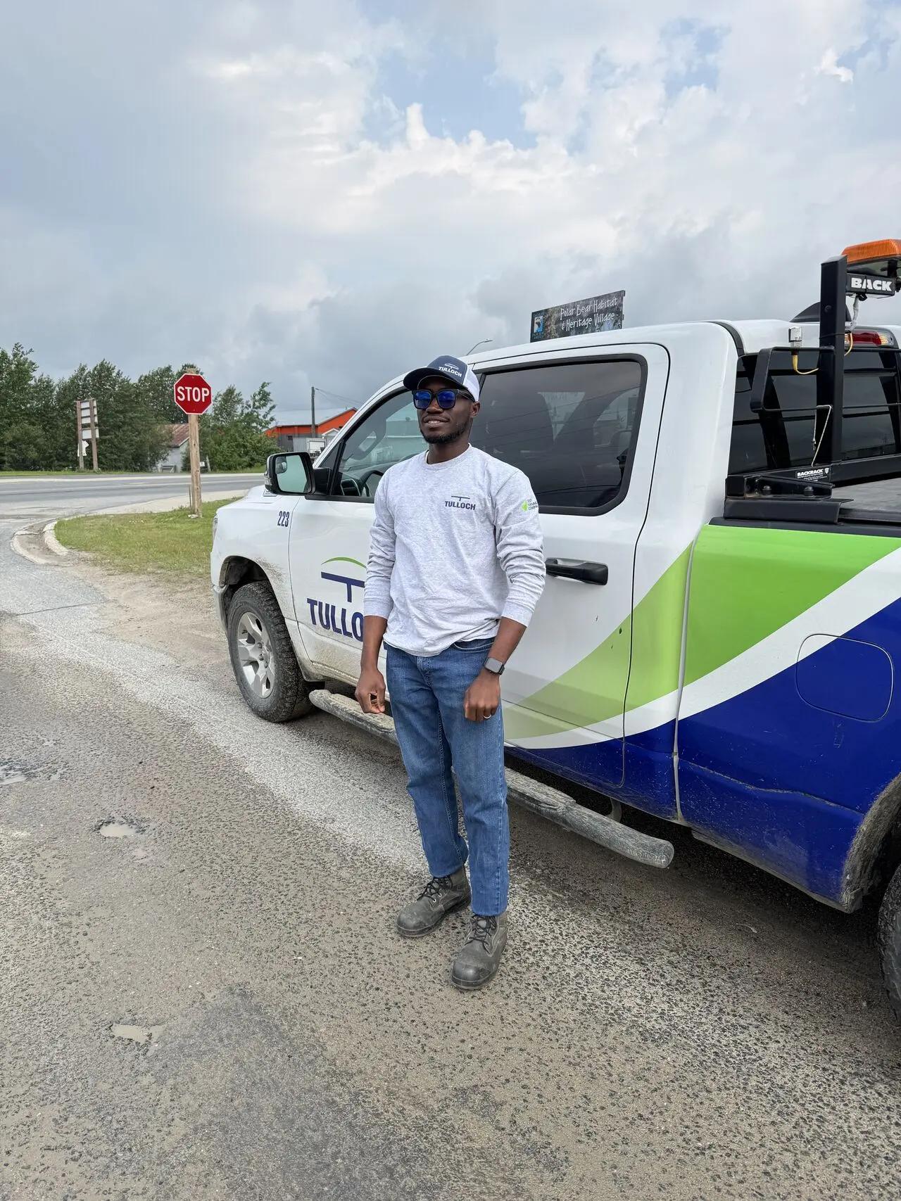 TULLOCH technician in front of truck.