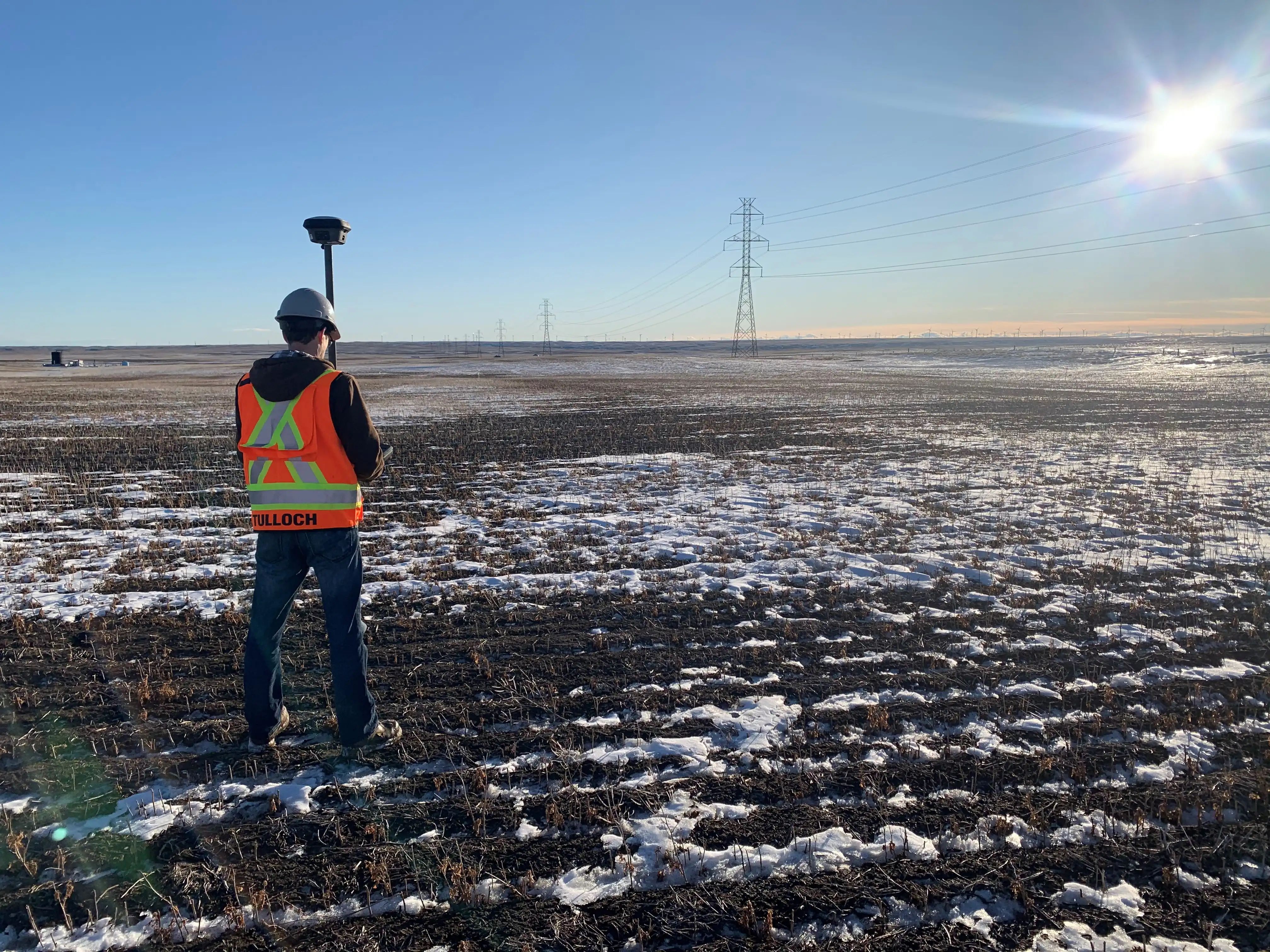 TULLOCH geomatics field technician collecting survey data on an energy project.