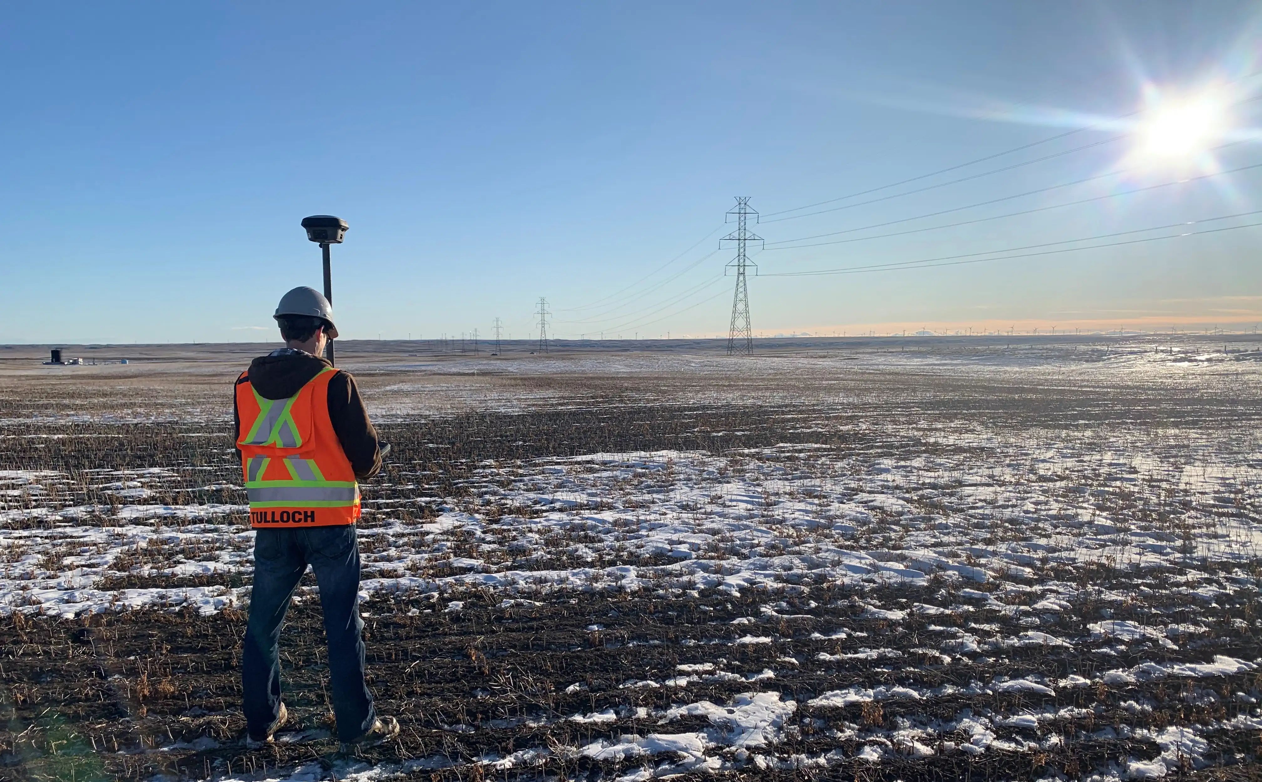 TULLOCH geomatics field technician collecting survey data on an energy project.