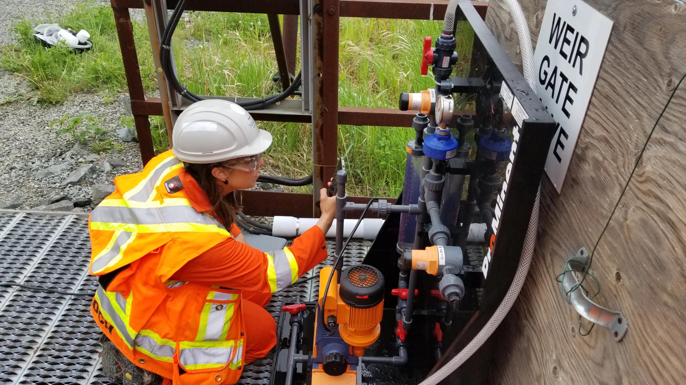 TULLOCH environmental field technician completing flow calibration monitoring at a water control structure.