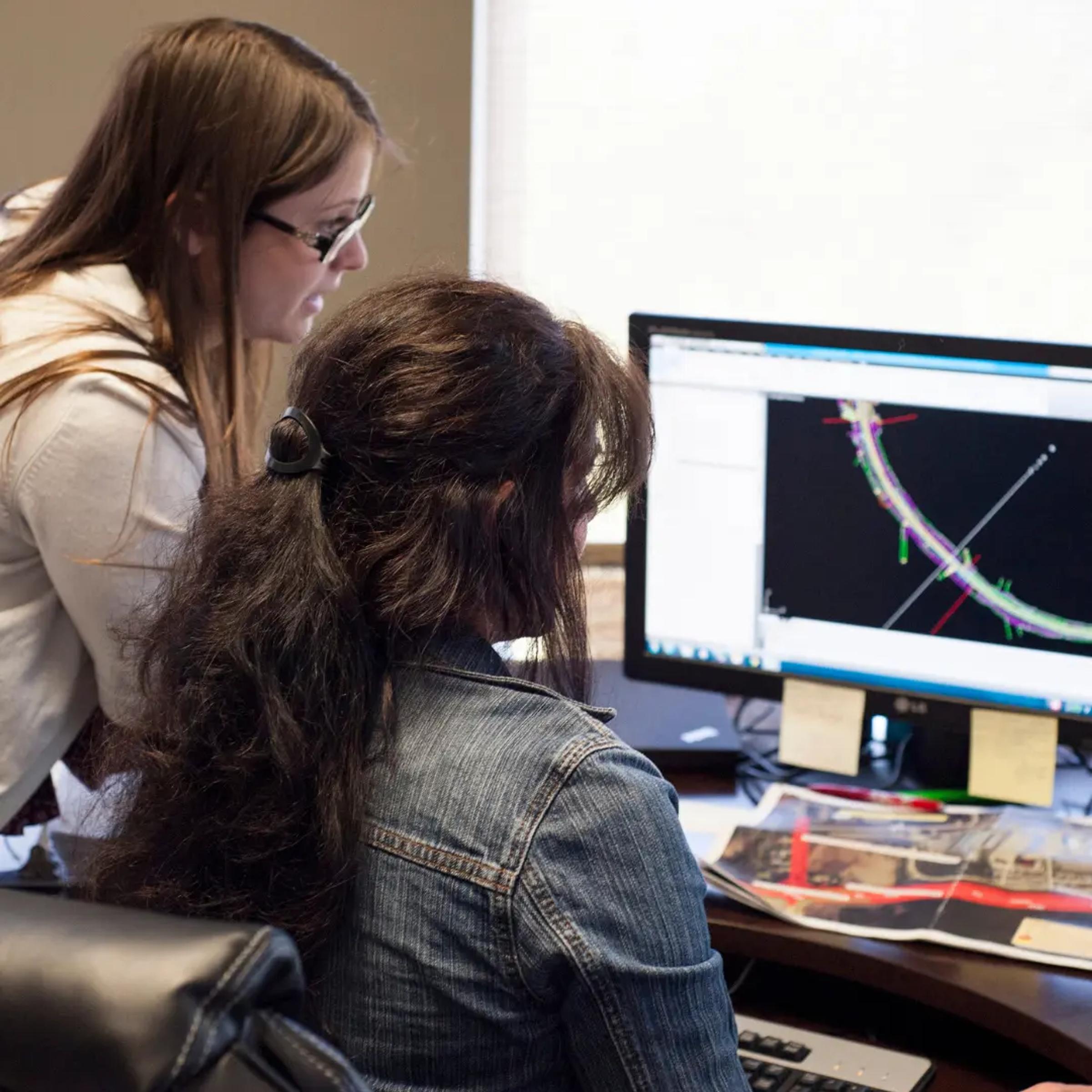 TULLOCH geomatics staff reviewing transportation survey data on a computer.