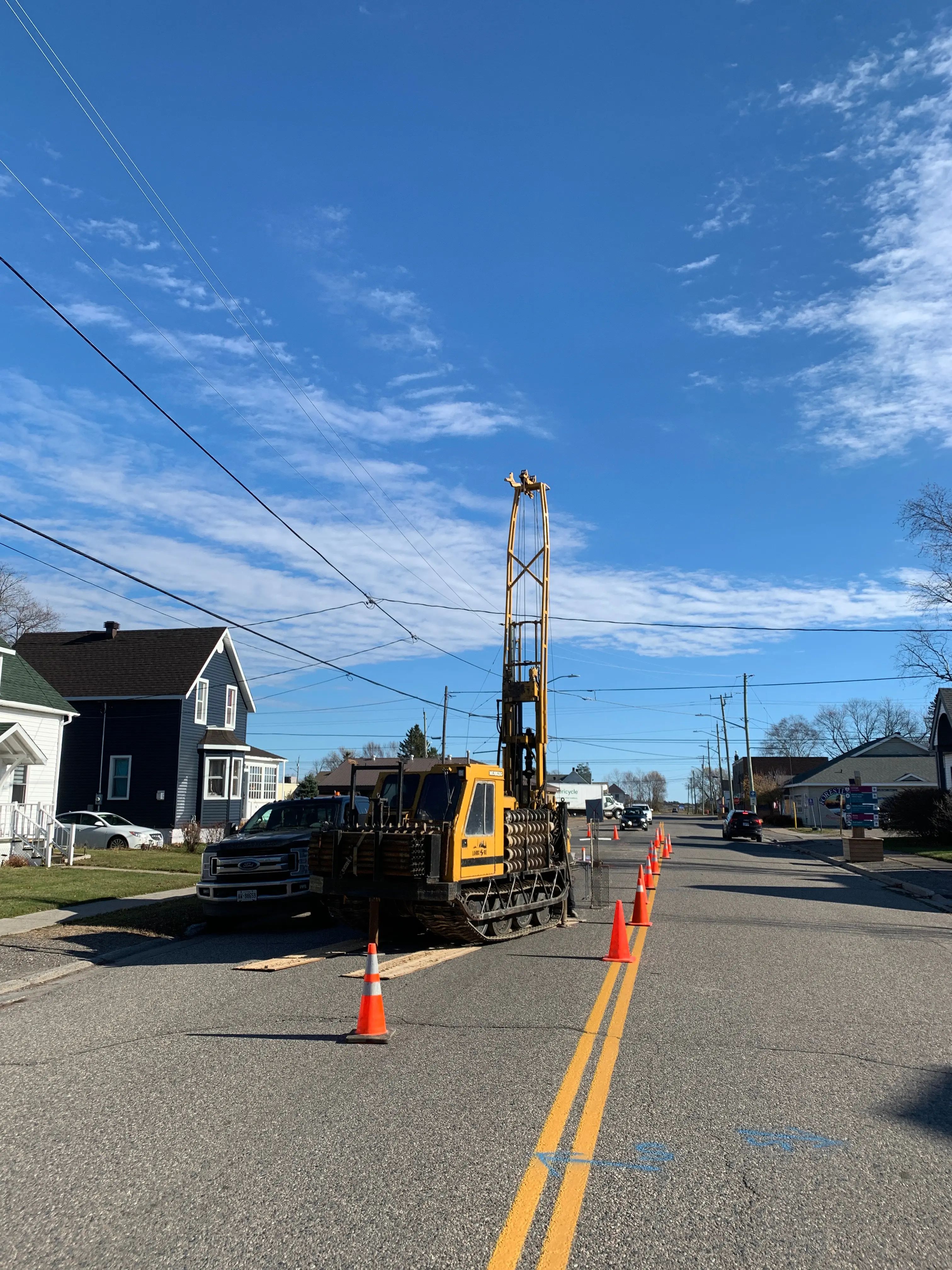 Drill working along a municipal road during active construction.