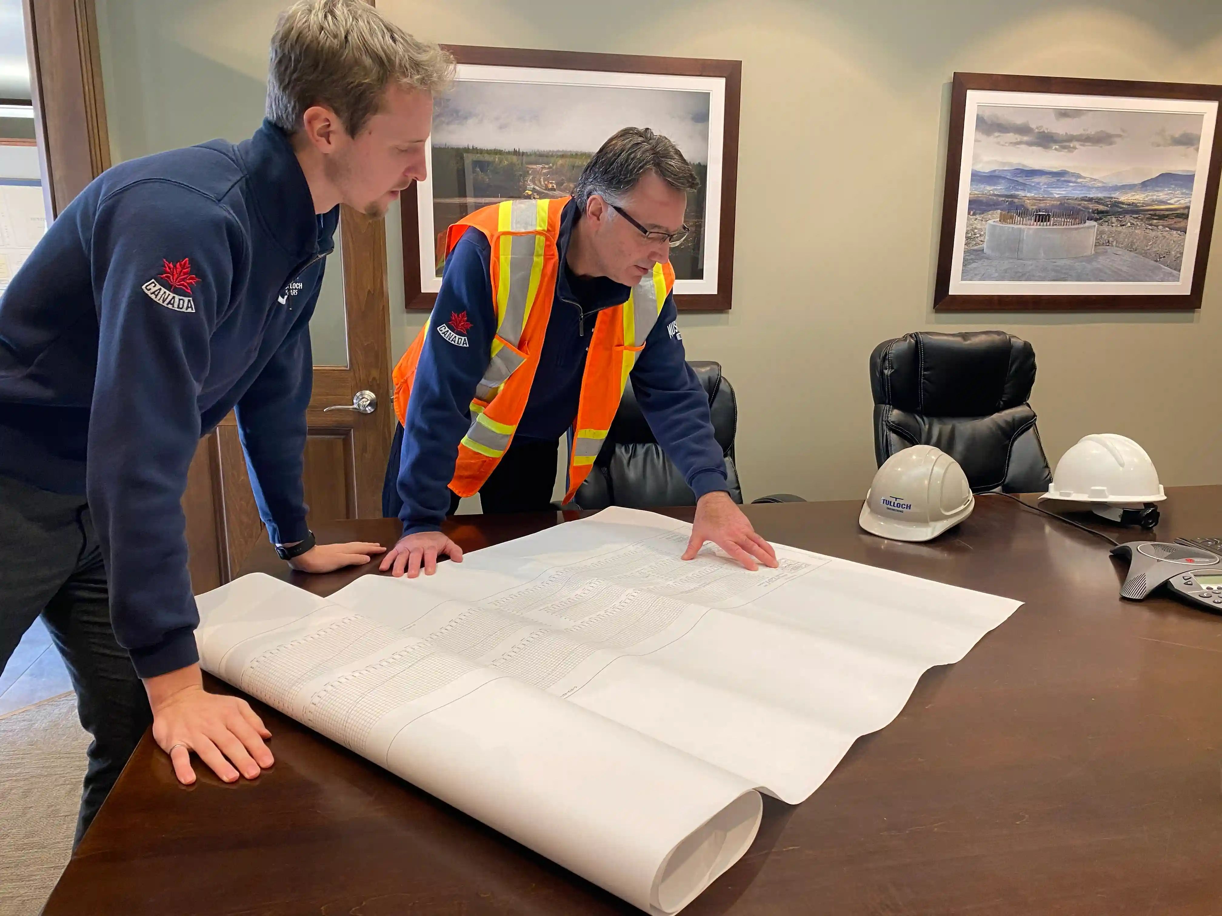 TULLOCH team reviewing plans for the Muskoka Forest subdivision development.