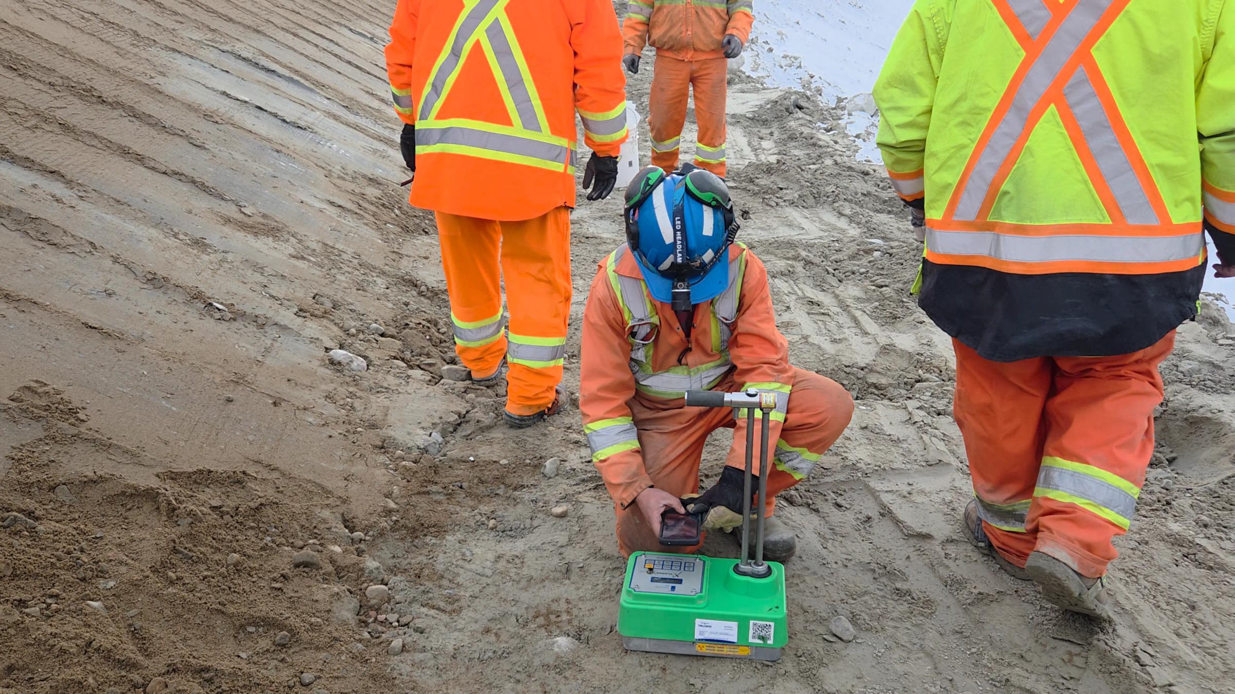TULLOCH field technician doing compaction testing with nuclear gauge.