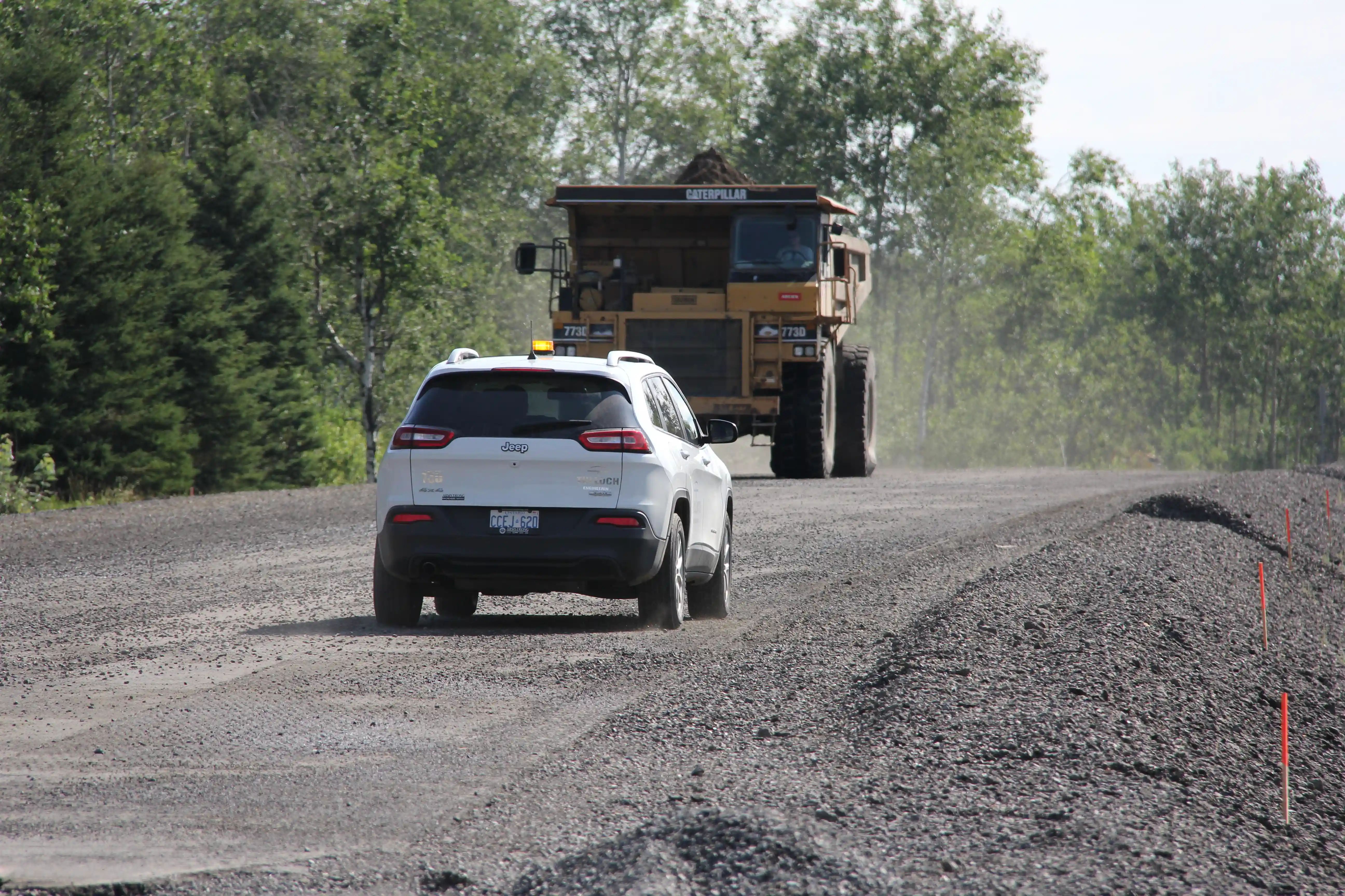 TULLOCH field technician and company vehicle travelling on a mine or industrial access road.