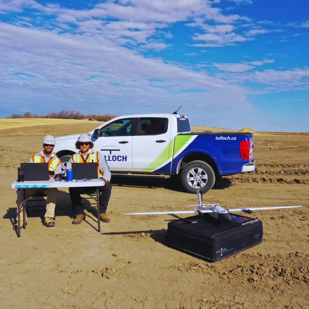 TULLOCH field team preparing drone survey equipment beside a company truck.