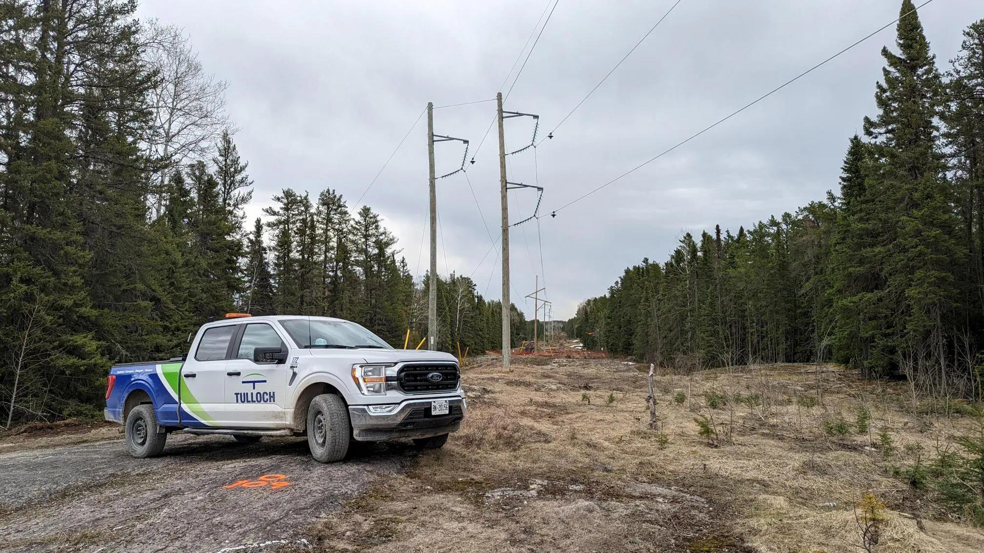 TULLOCH company truck positioned along a hydro transmission corridor.