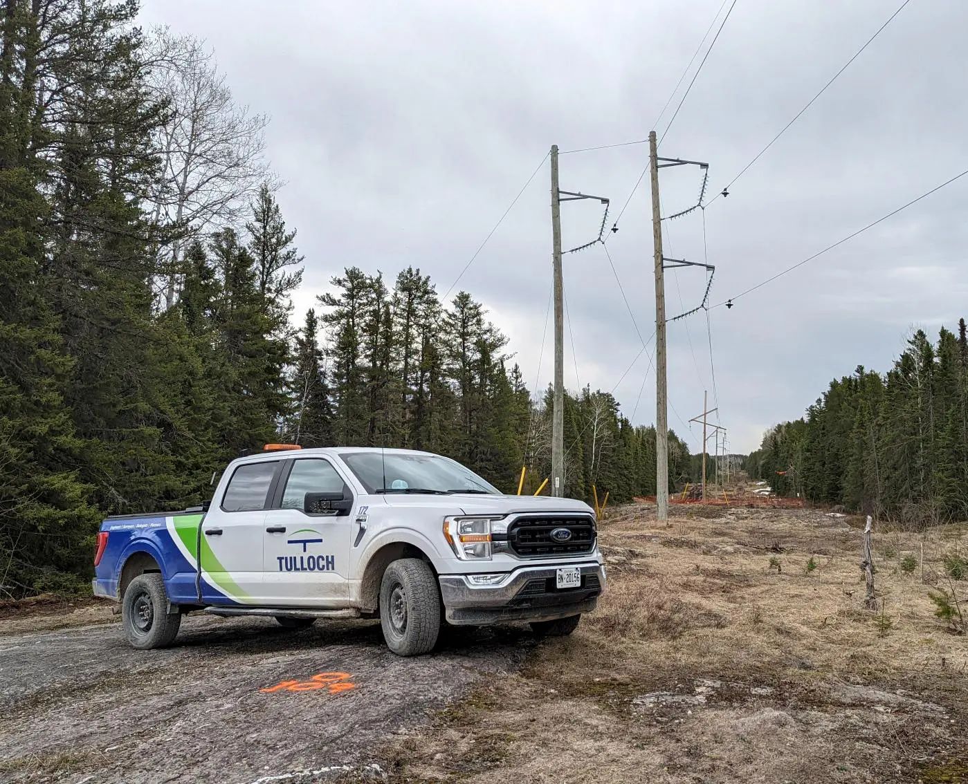 TULLOCH company truck positioned along a hydro transmission corridor.