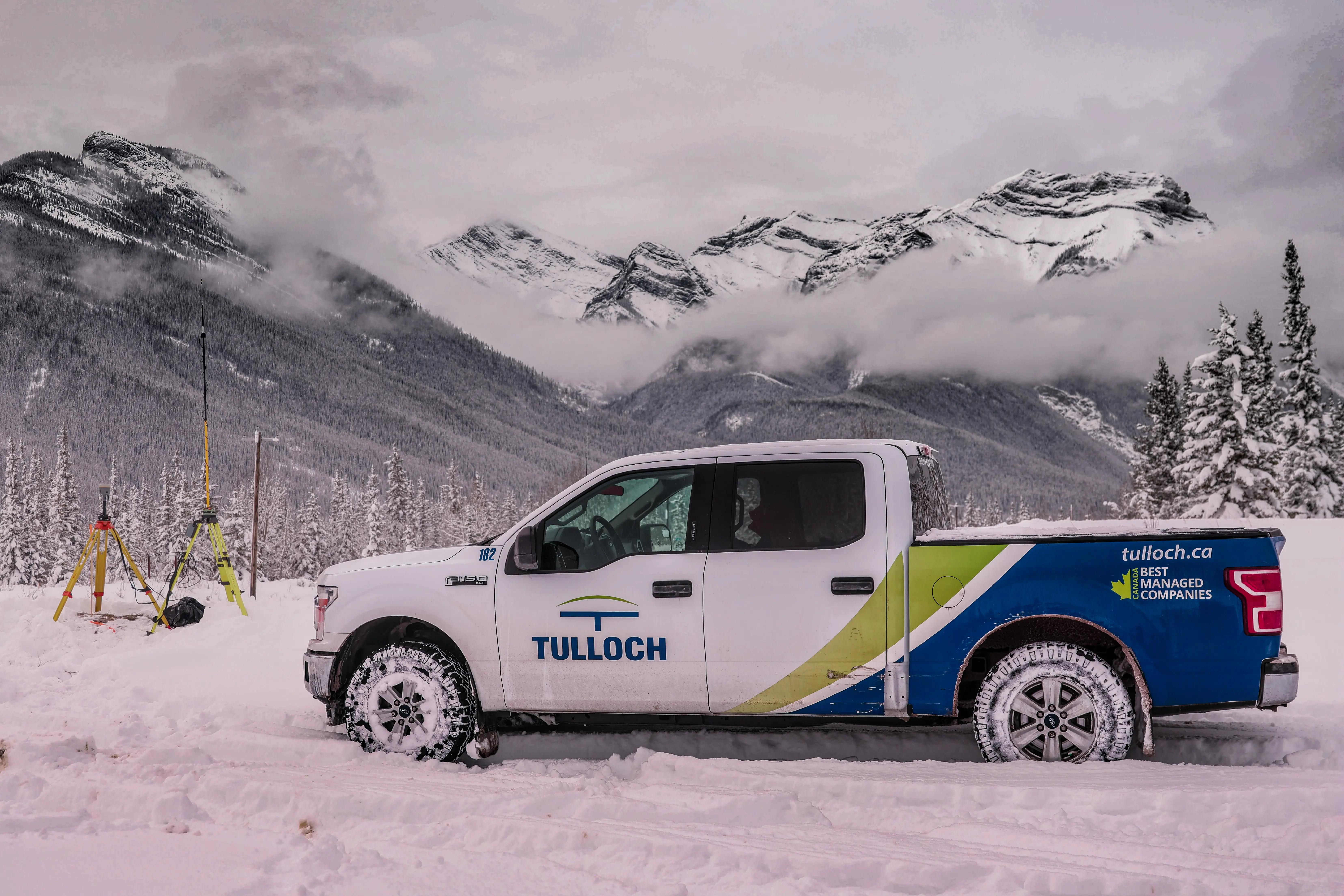 TULLOCH company truck at a winter project site in the Alberta Rockies.