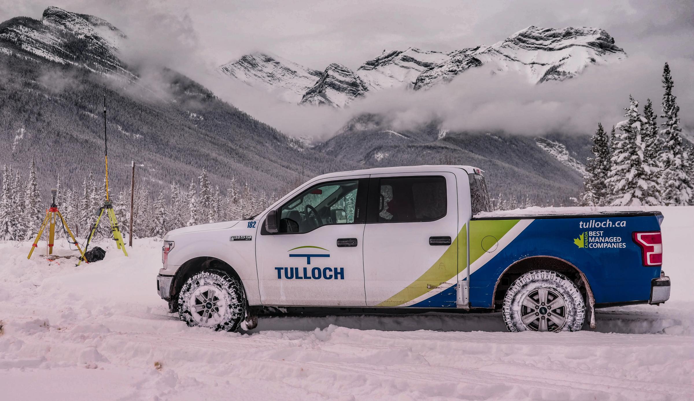 TULLOCH company truck at a winter project site in the Alberta Rockies.