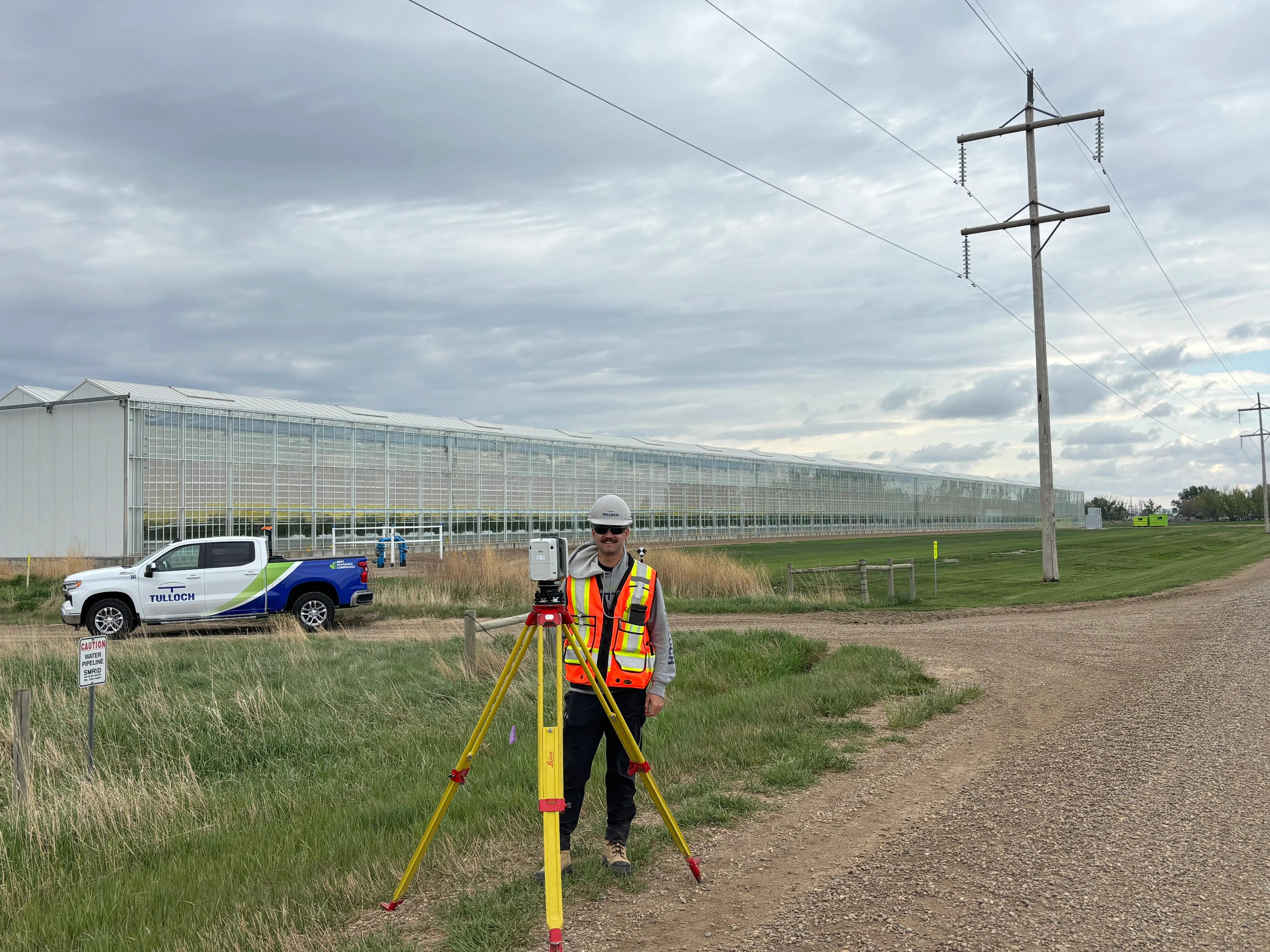 TULLOCH surveyor collecting field data along a transmission line corridor.