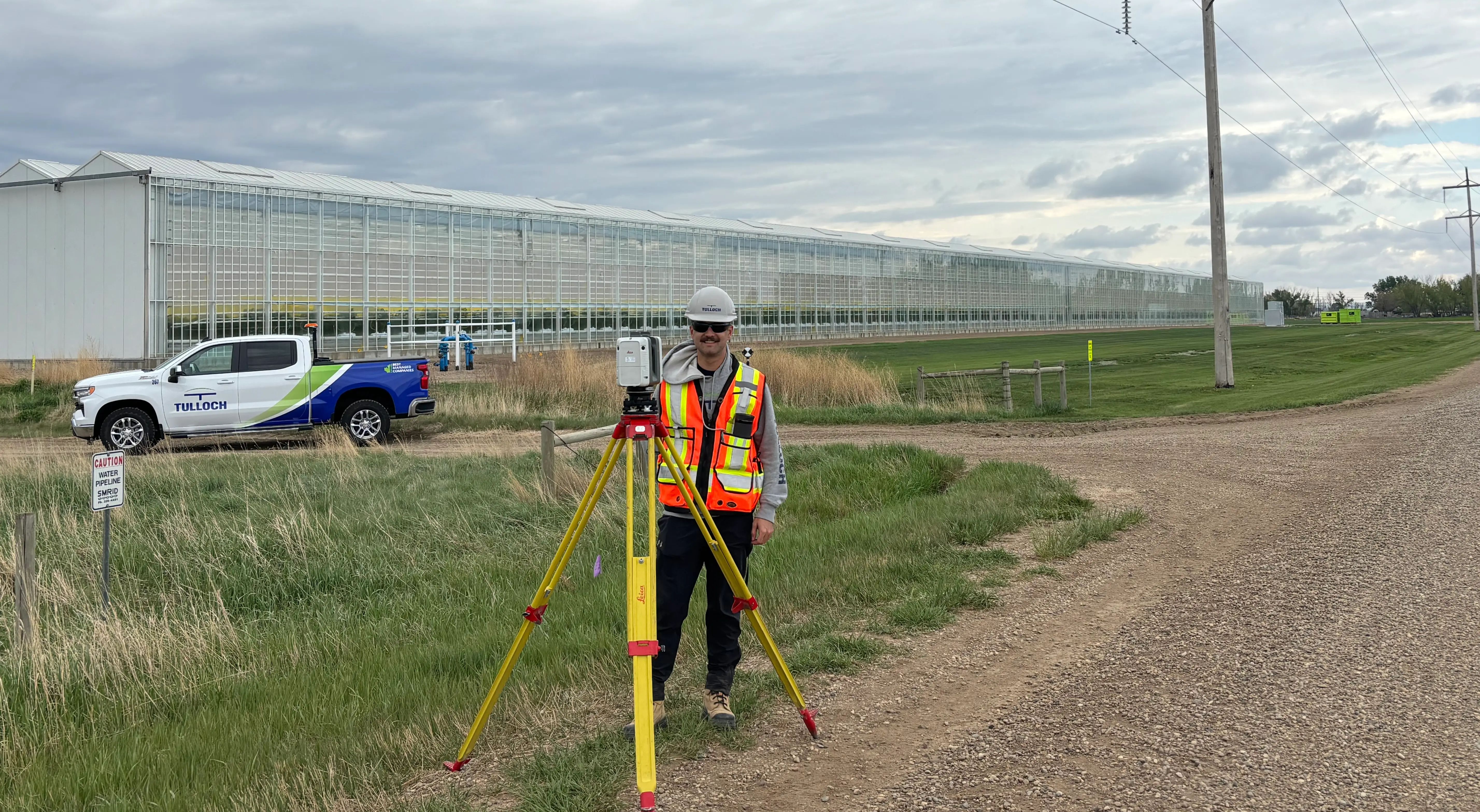 TULLOCH surveyor collecting field data along a transmission line corridor.