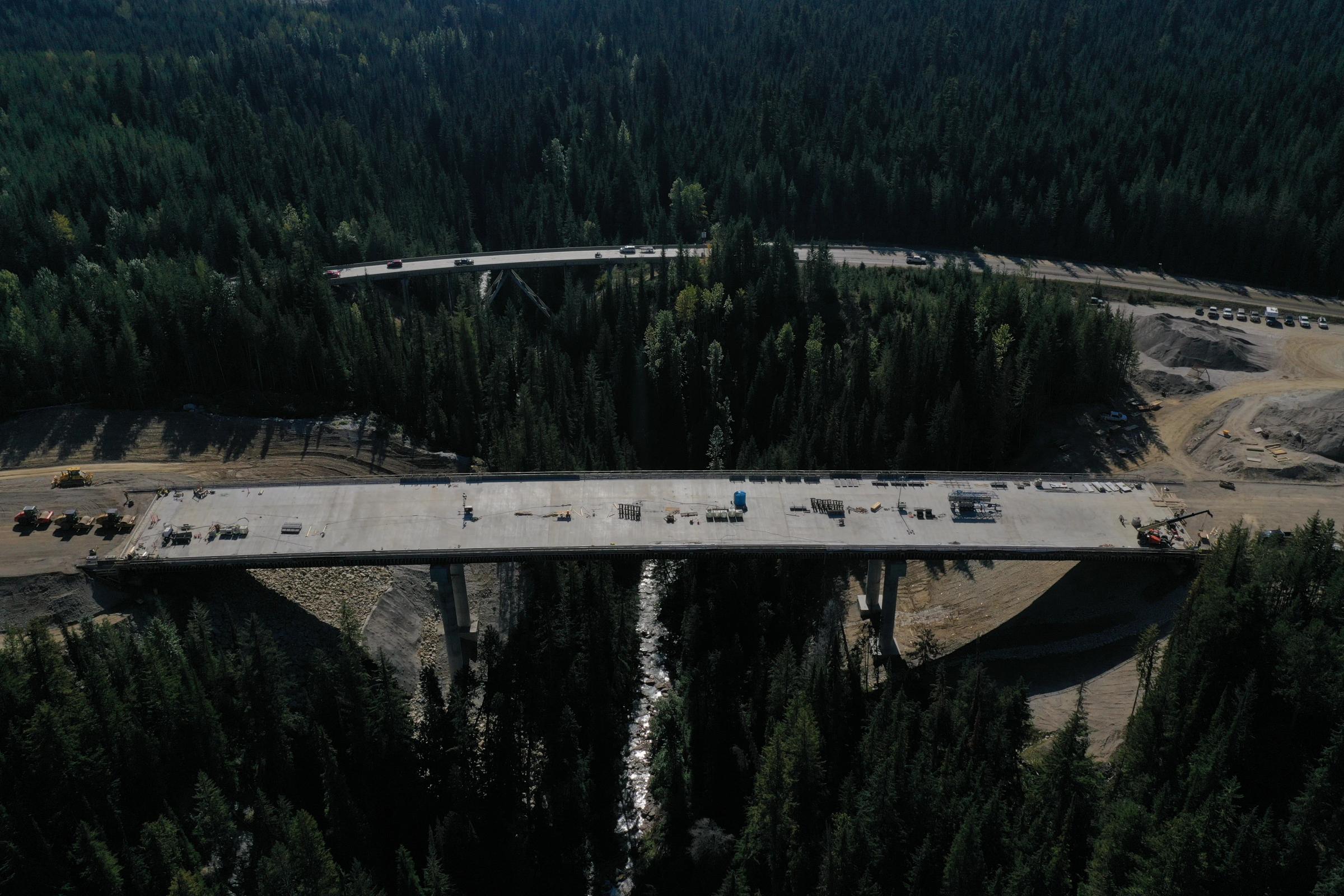 Aerial view of a bridge crossing in a remote forested area.