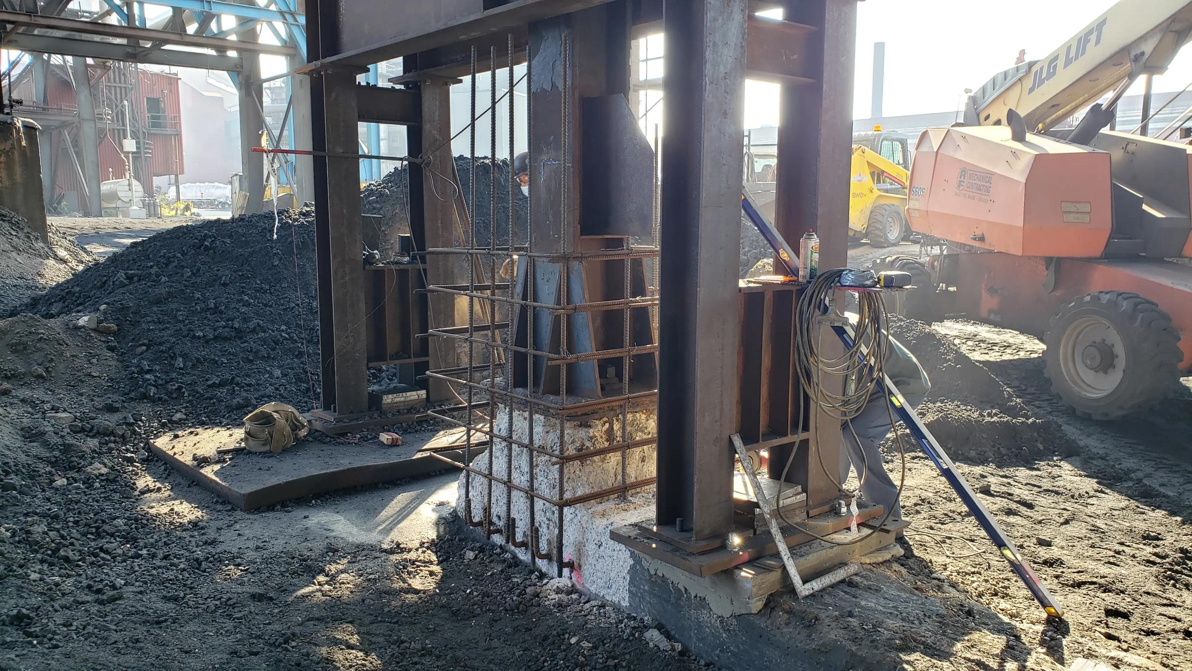 Steel columns and reinforced concrete supports during industrial construction work.
