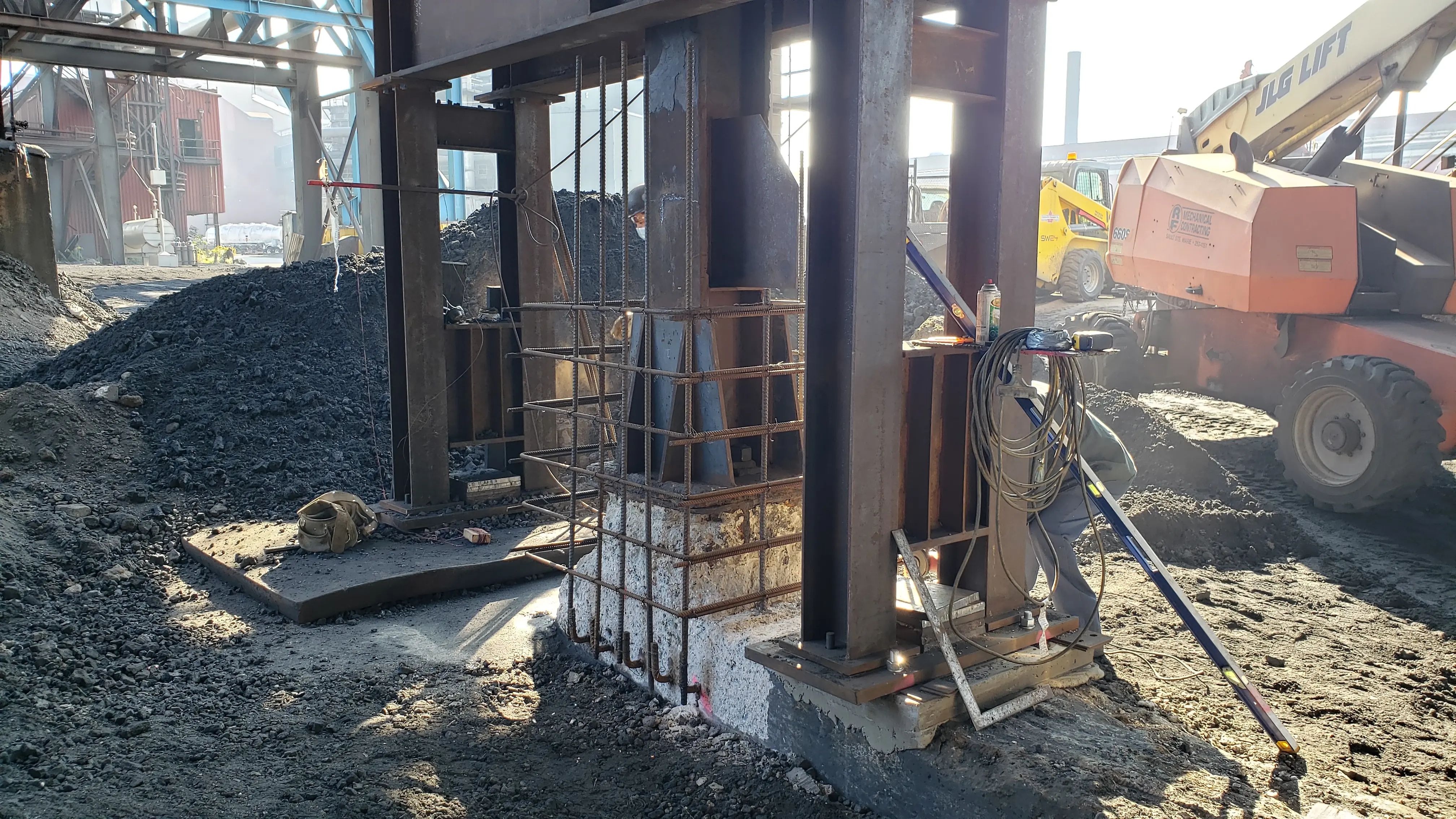 Steel columns and reinforced concrete supports during industrial construction work.