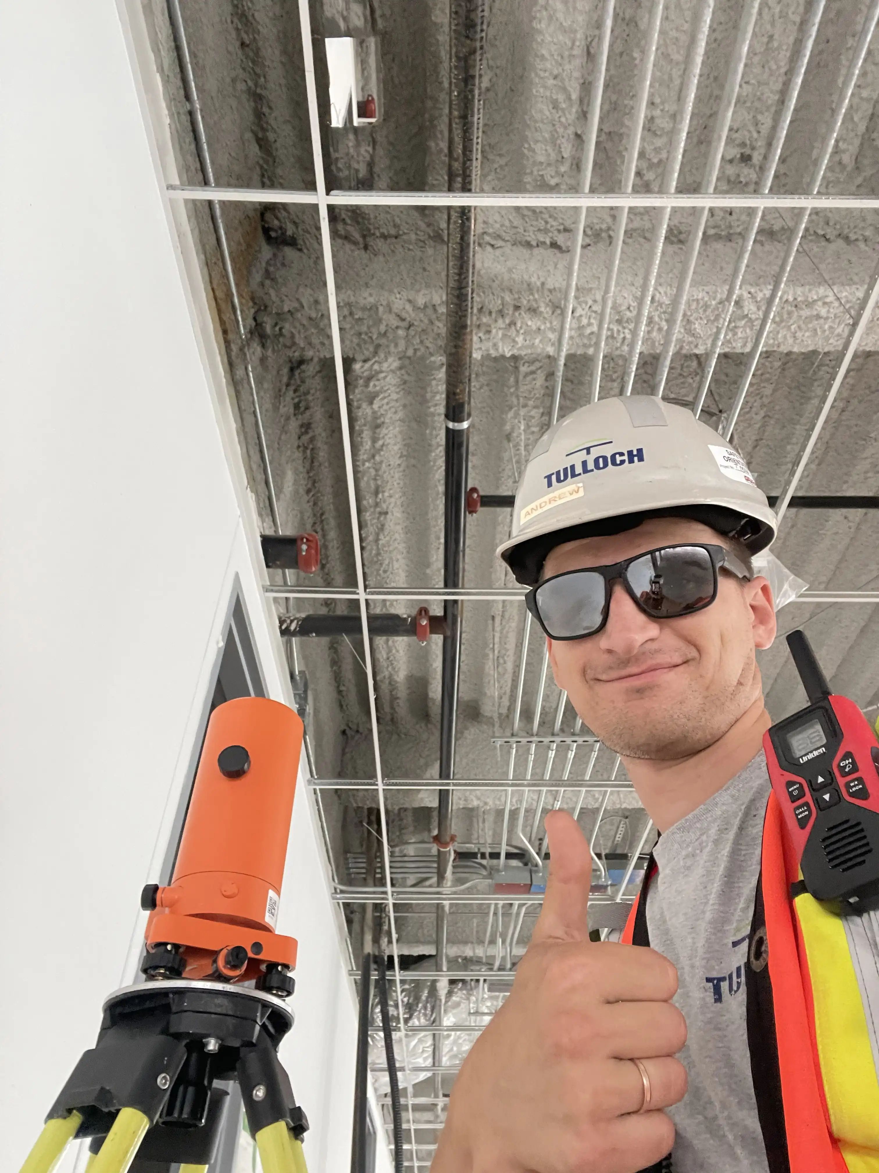 TULLOCH field surveyor using a total station on a construction site.