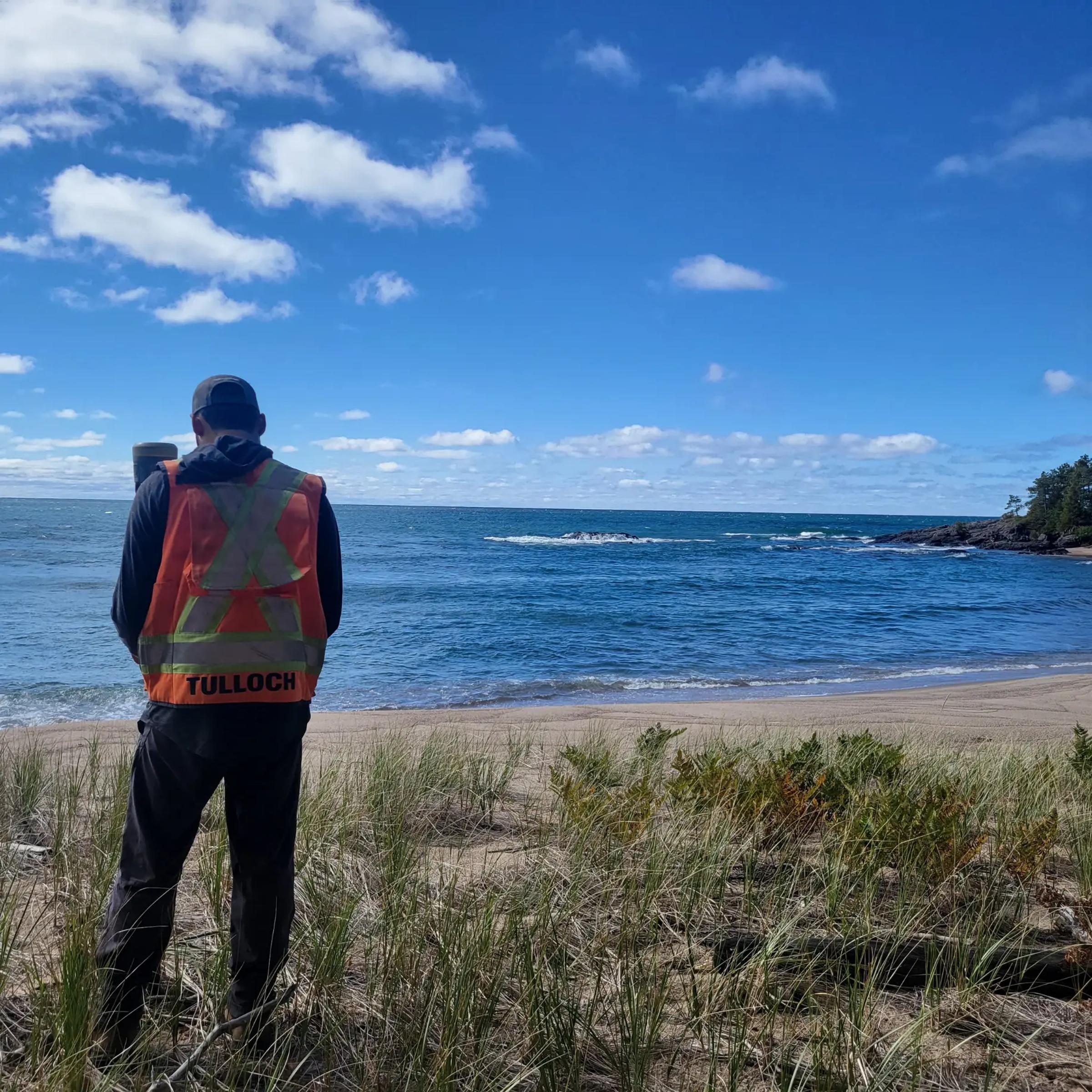 TULLOCH field specialist reviewing shoreline conditions at Batchewana Bay.