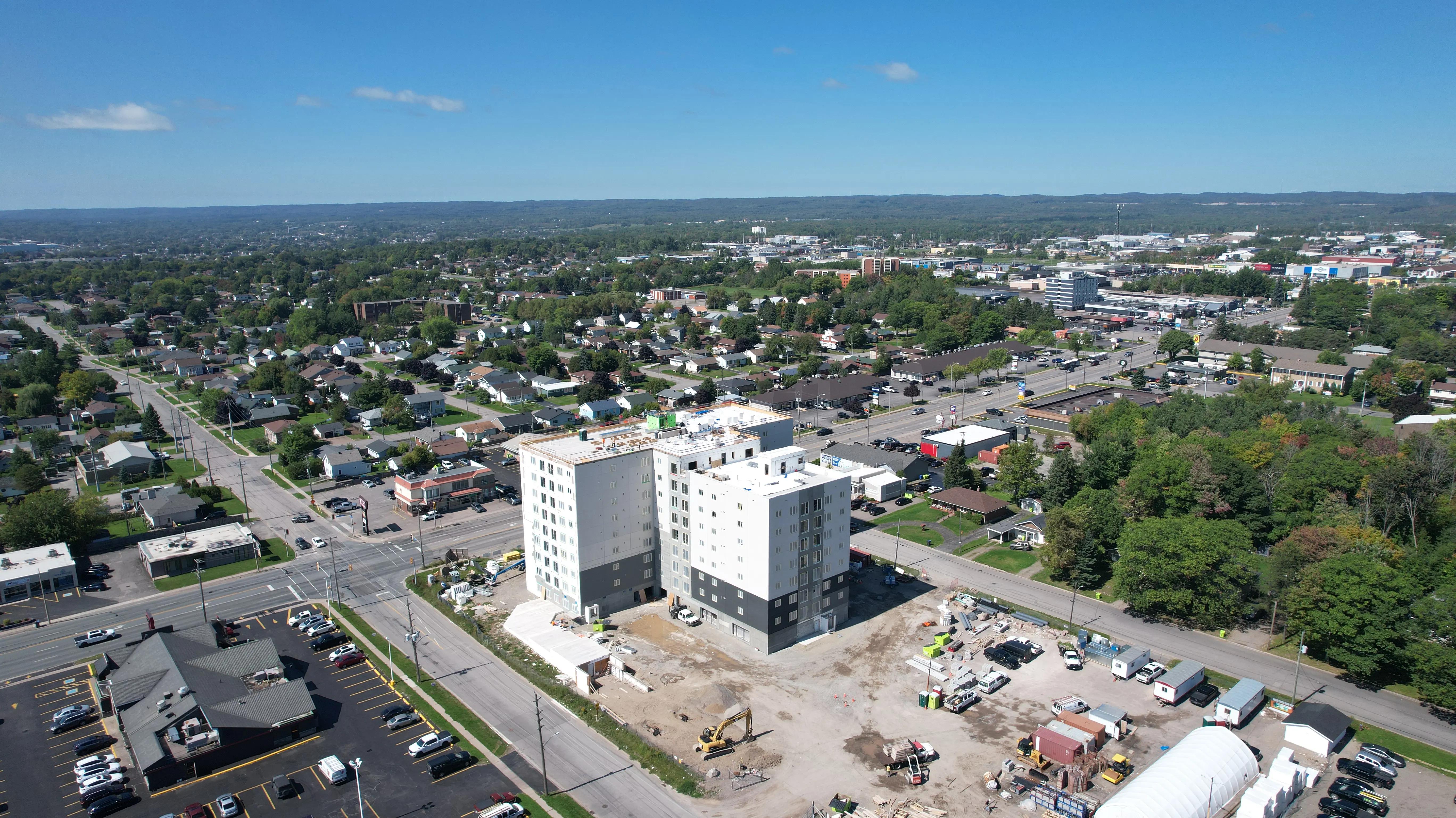 Aerial view of a multi-storey residential development under construction in an urban neighbourhood.