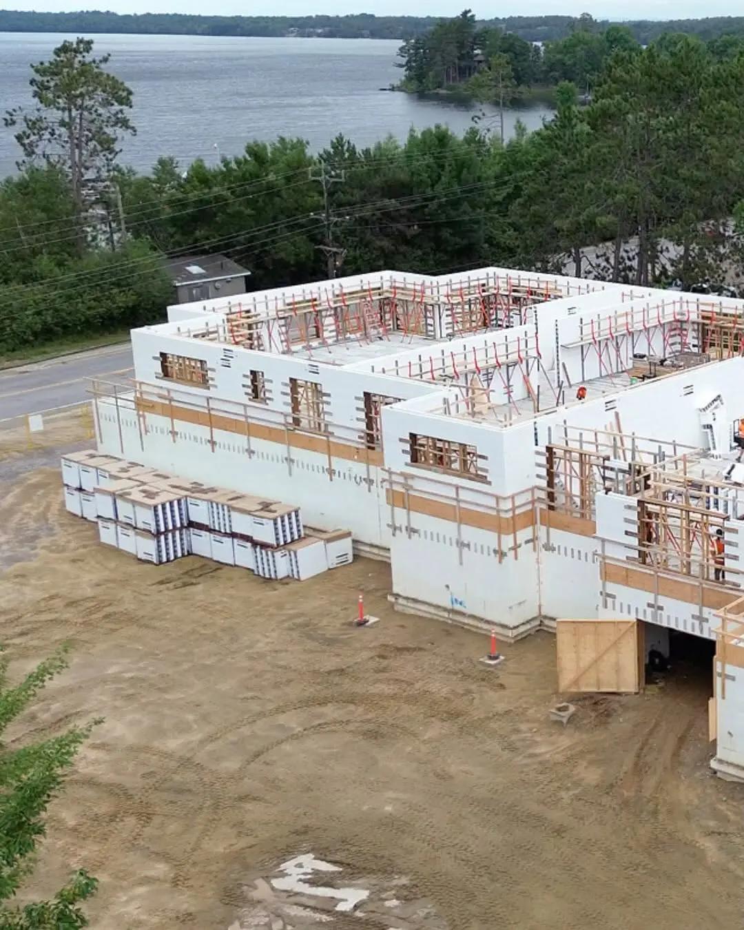 Foundation and concrete walls under construction for a multi-unit building.
