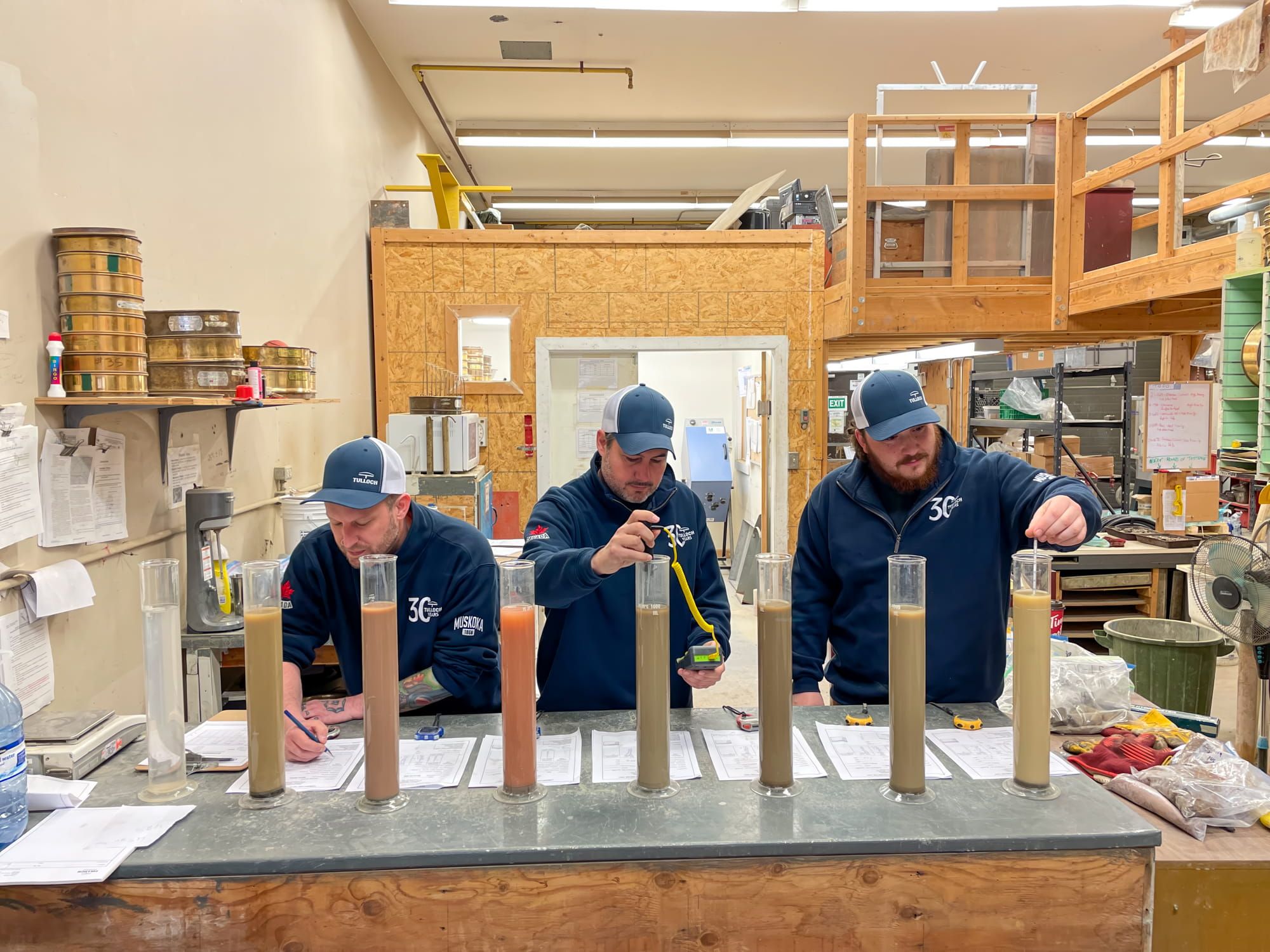 Materials testing staff preparing or reviewing samples in the laboratory.