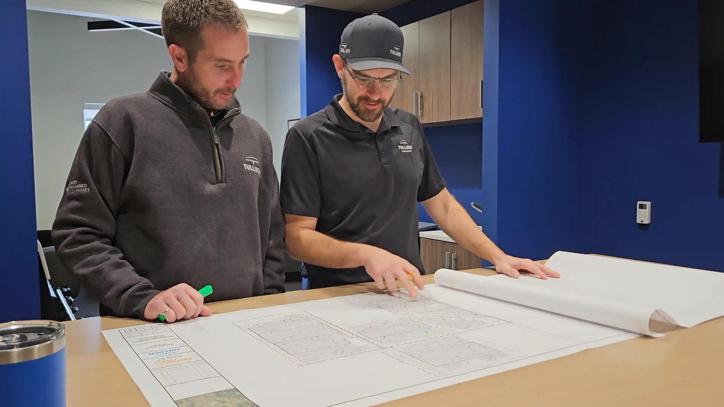 TULLOCH team members reviewing project plans for the Pendleton solar project.