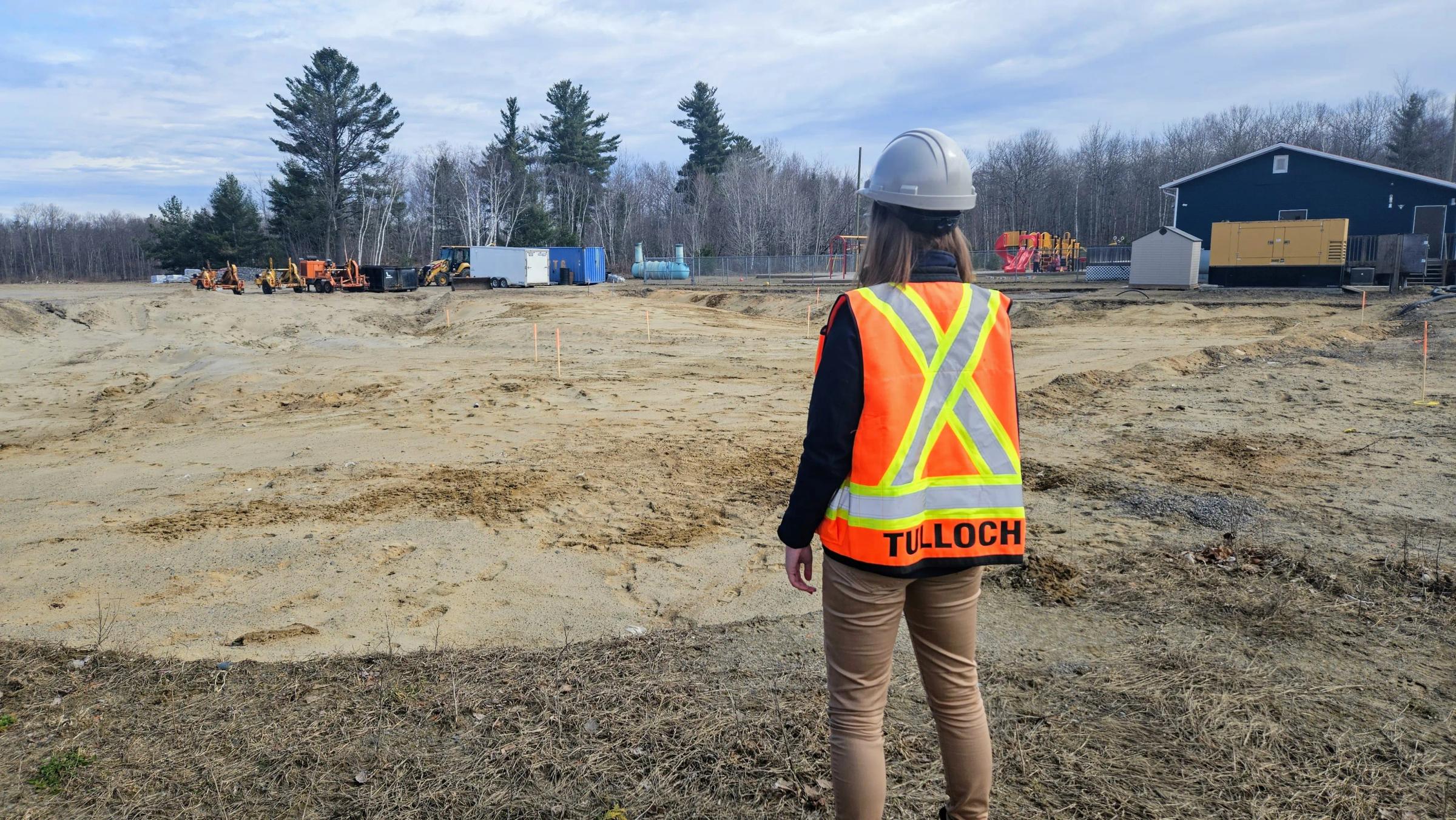 TULLOCH field technician reviewing conditions at an active construction site.