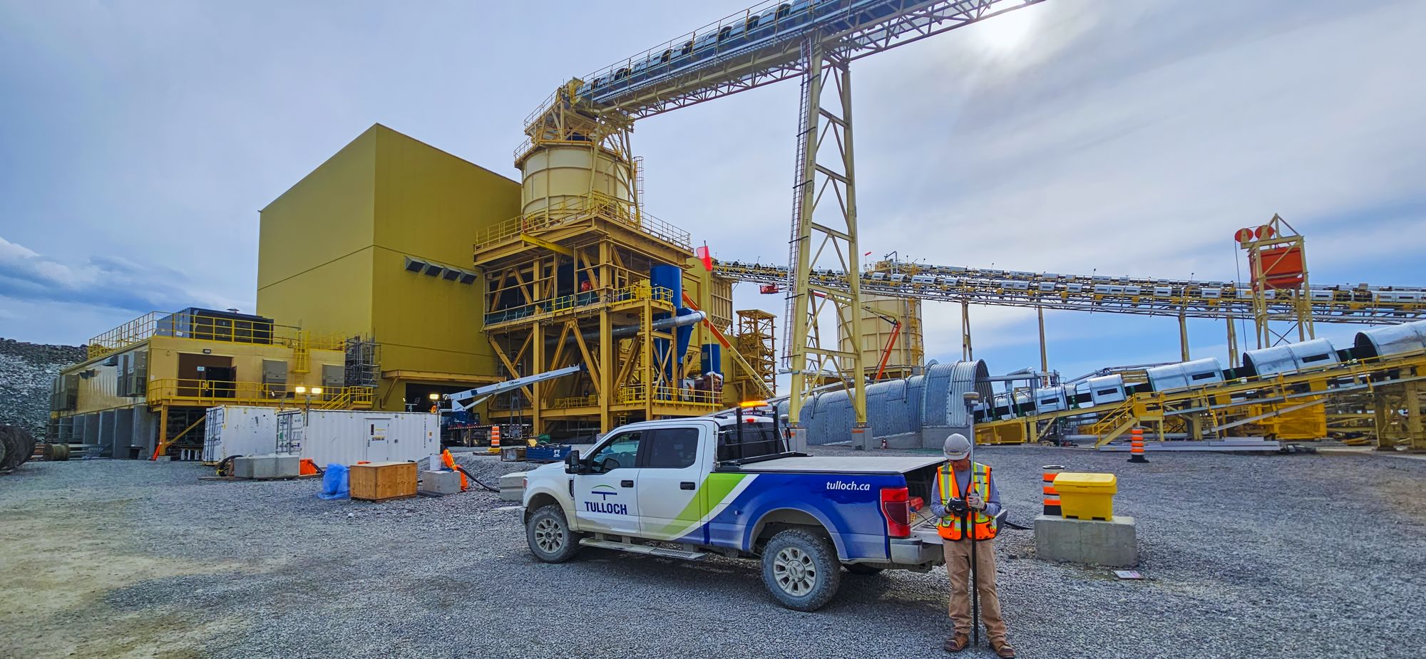 TULLOCH field vehicle and staff at a large ming processing facility.