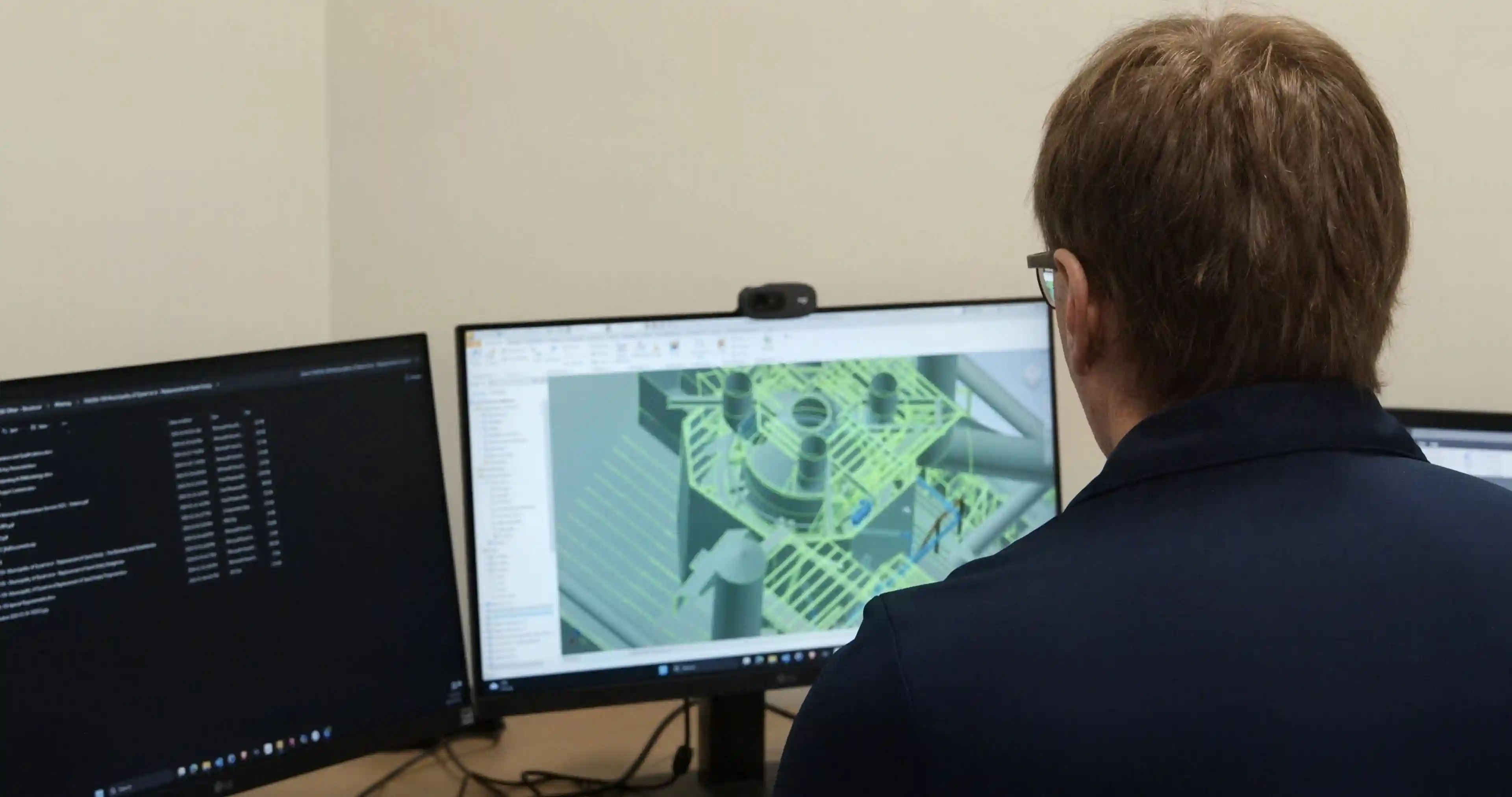 TULLOCH engineering team member reviewing an industrial 3D model at a workstation.