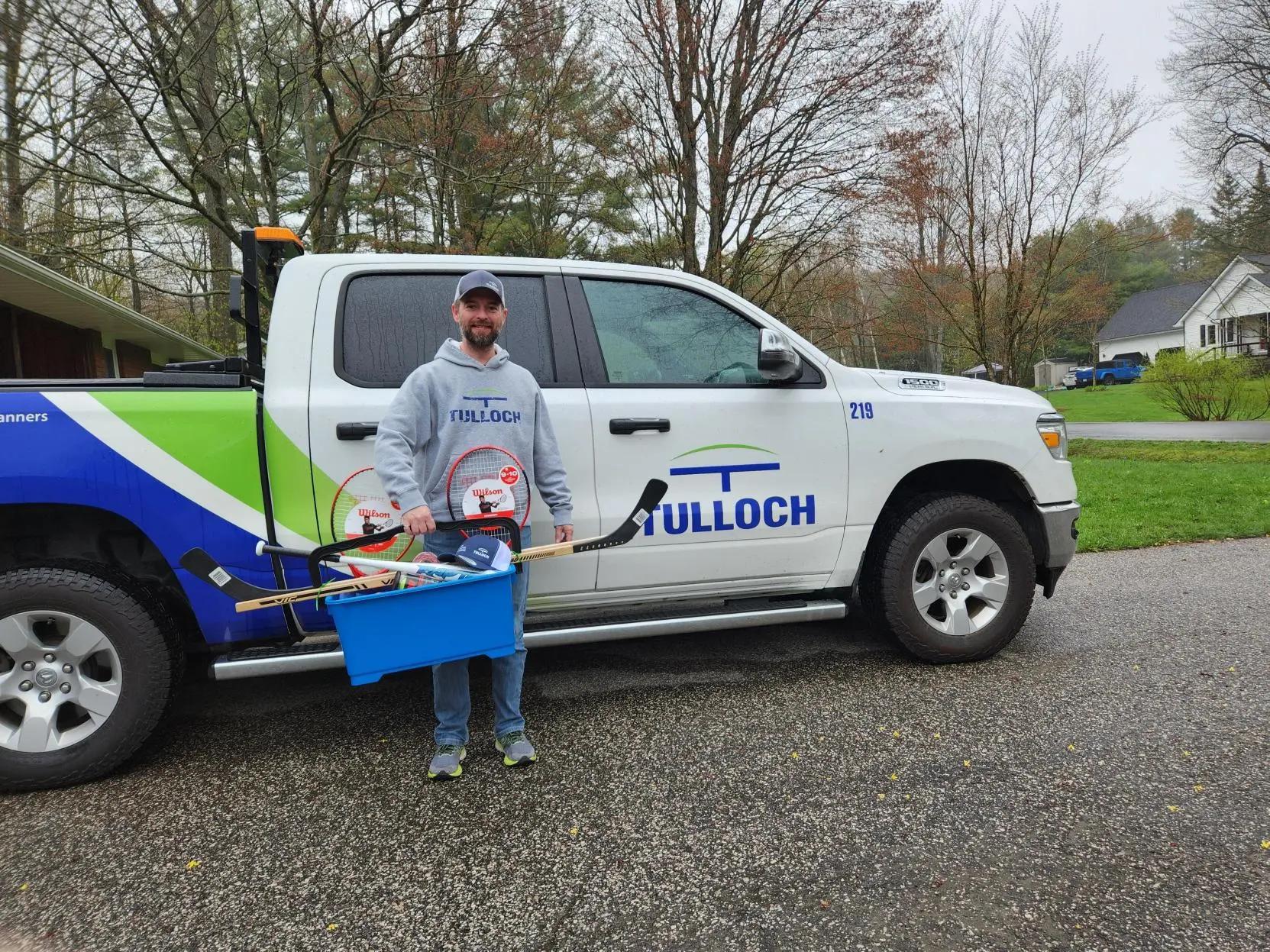 TULLOCH staff member with donation for Henvey Inlet.