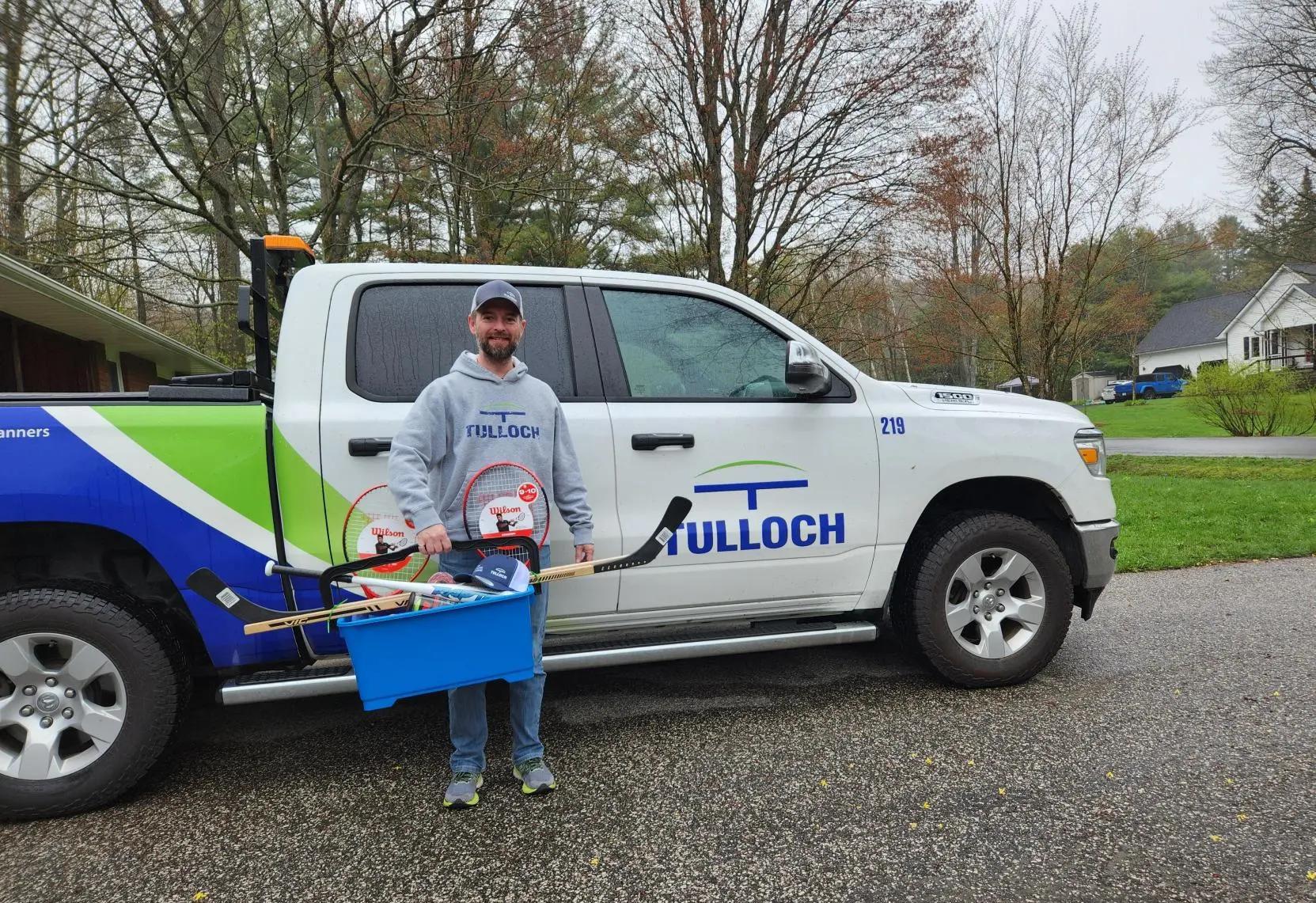TULLOCH staff member with donation for Henvey Inlet.