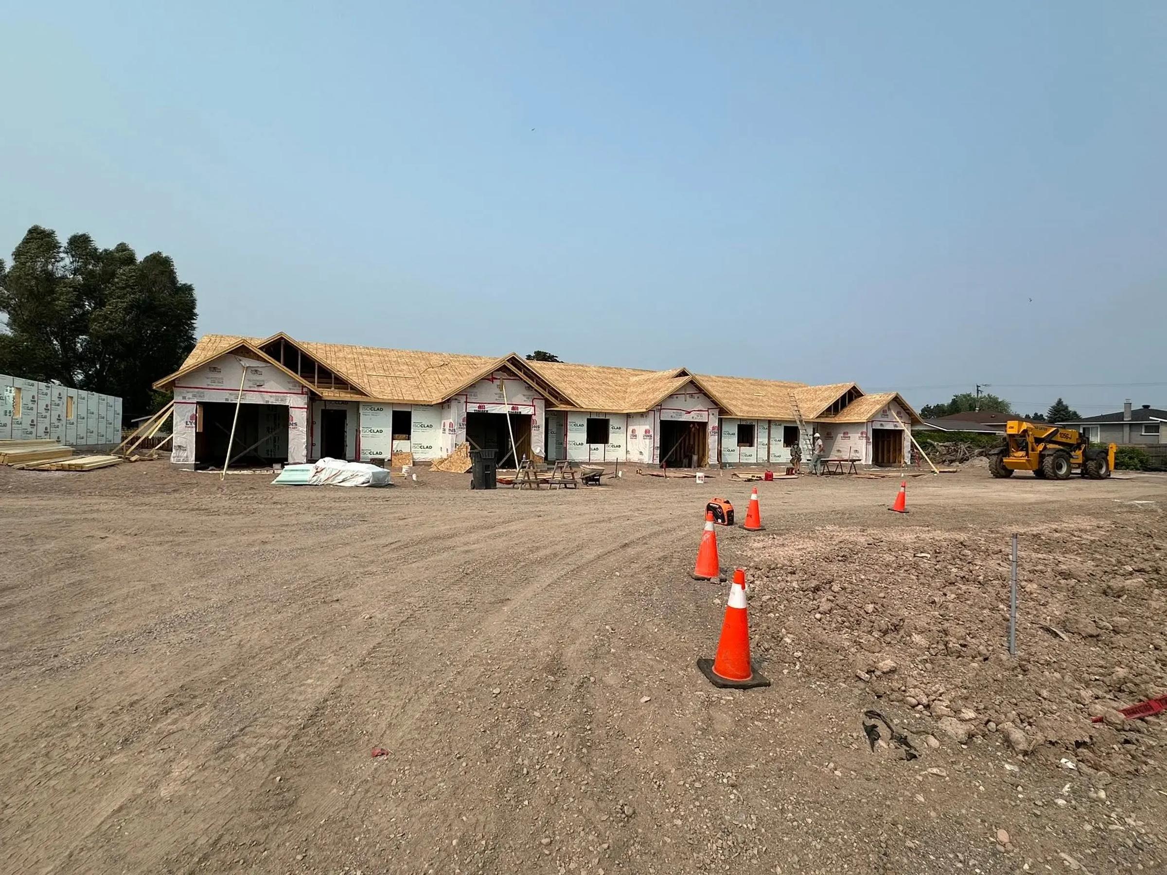 Korah Road project building under construction with site grading in progress.