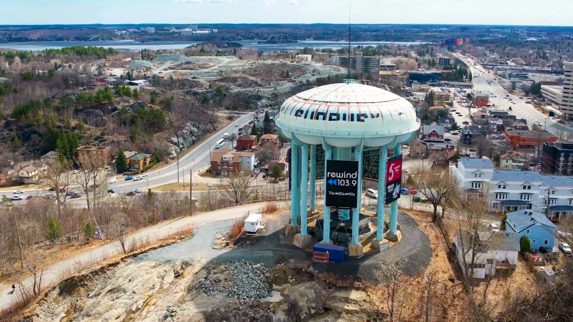 Aerial view of a municipal water tower and surrounding community.