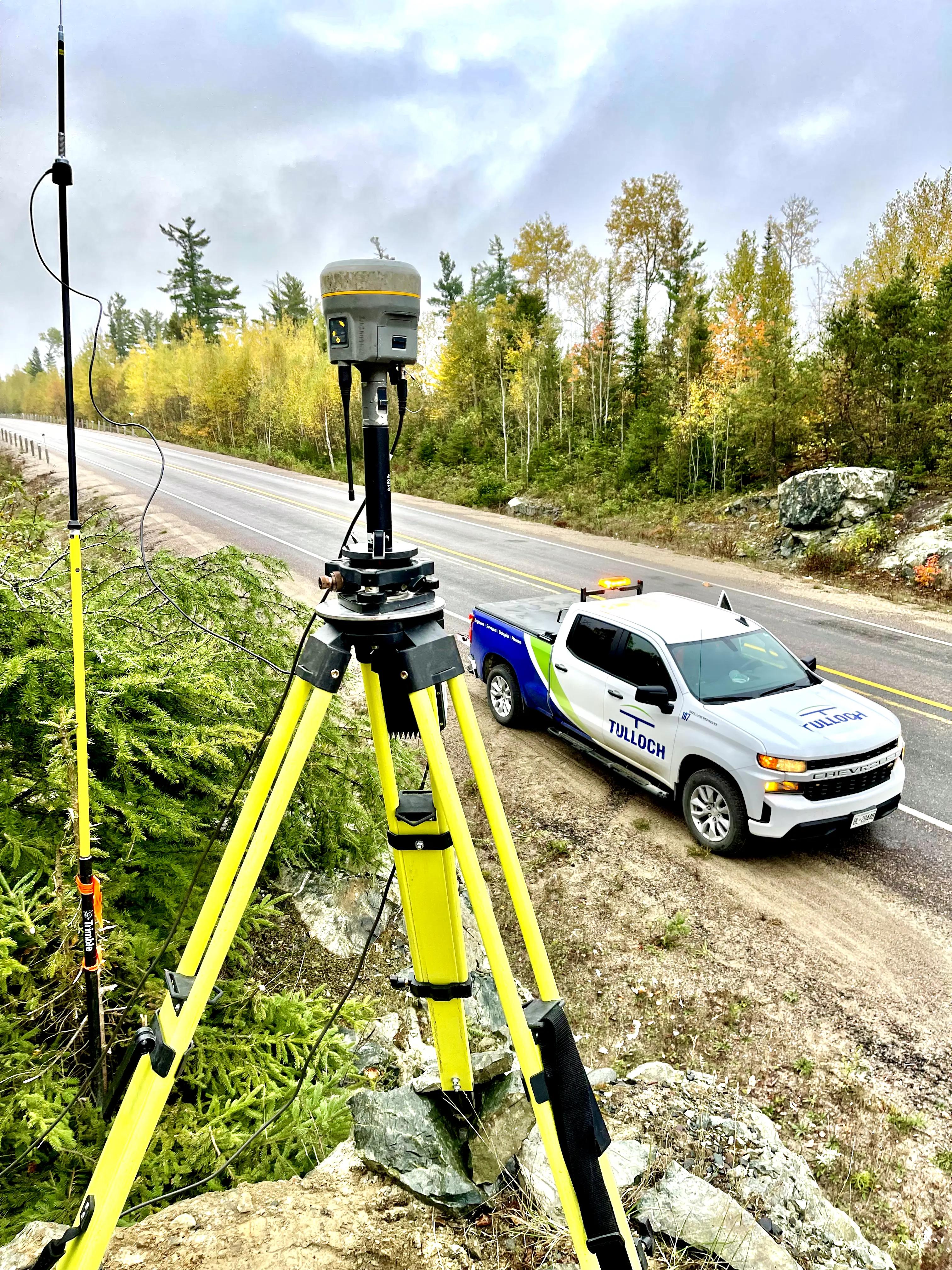 Survey equipment beside Highway 3 with a TULLOCH vehicle nearby.