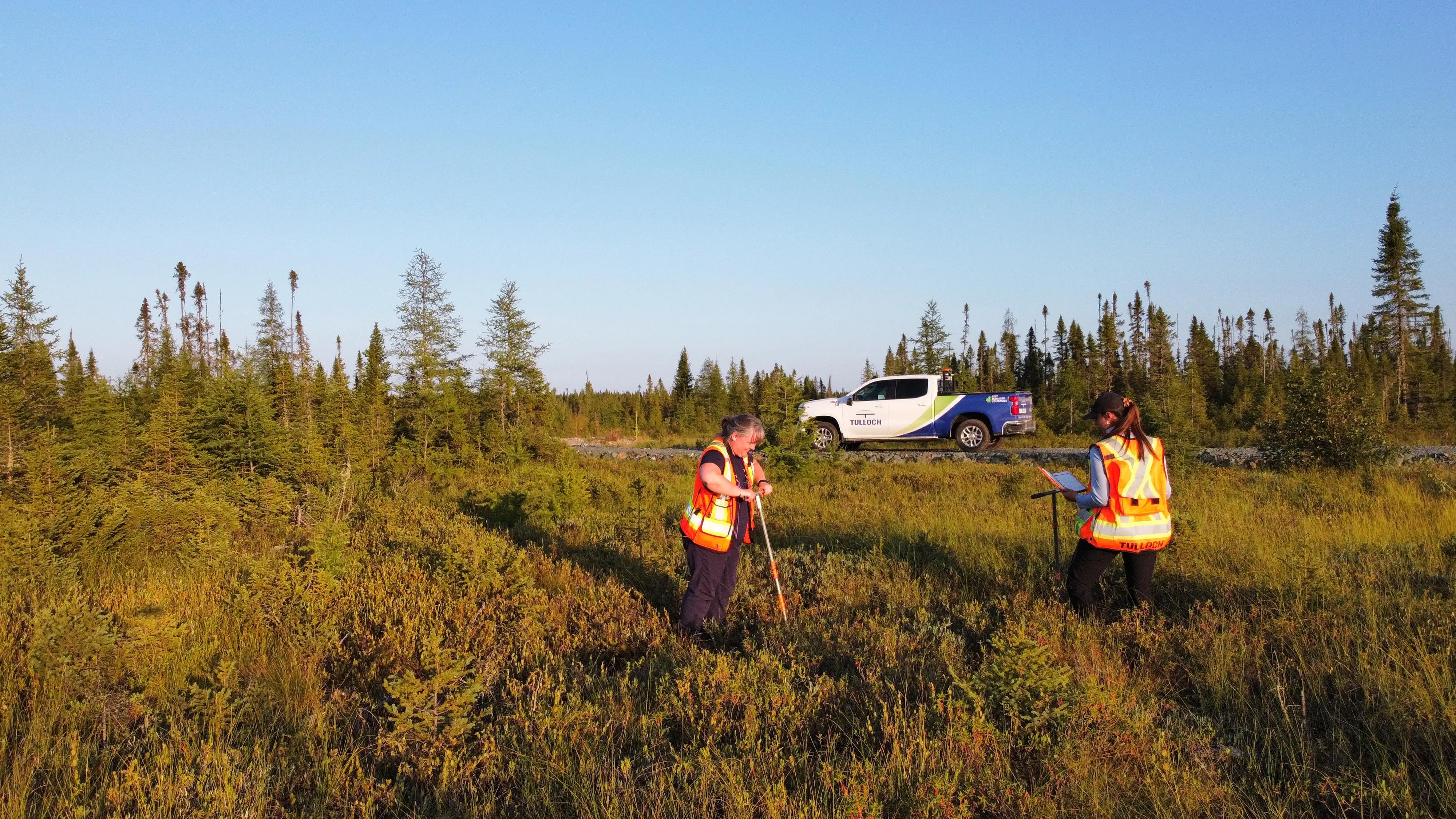 TULLOCH environmental field technicians completing soil sampling in a remote area.
