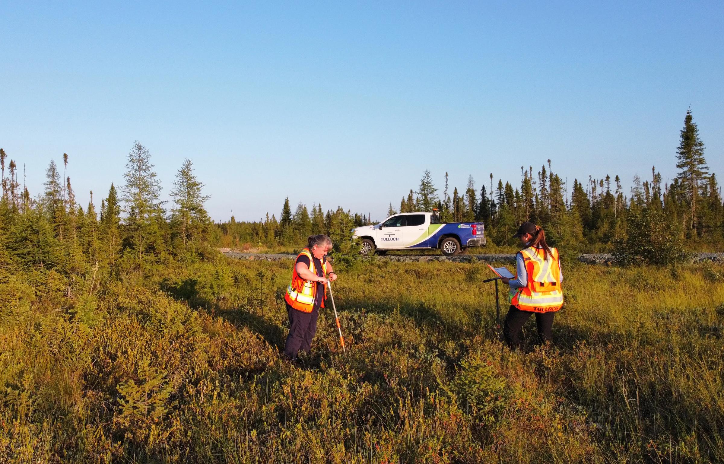 TULLOCH environmental field technicians completing soil sampling in a remote area.