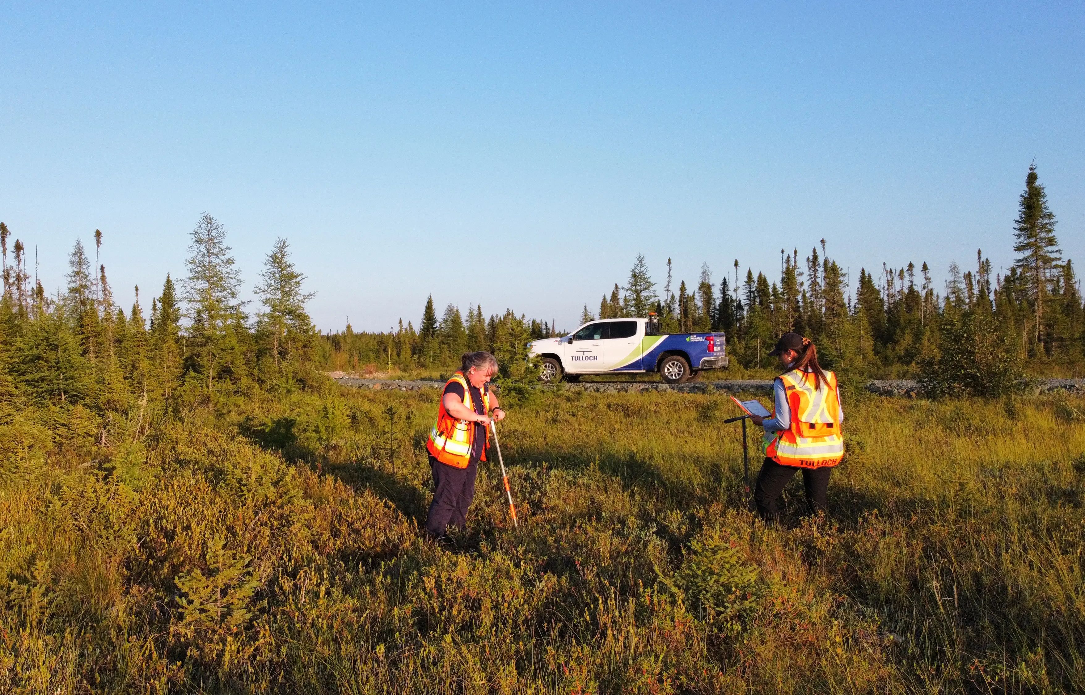 TULLOCH environmental field technicians completing soil sampling in a remote area.