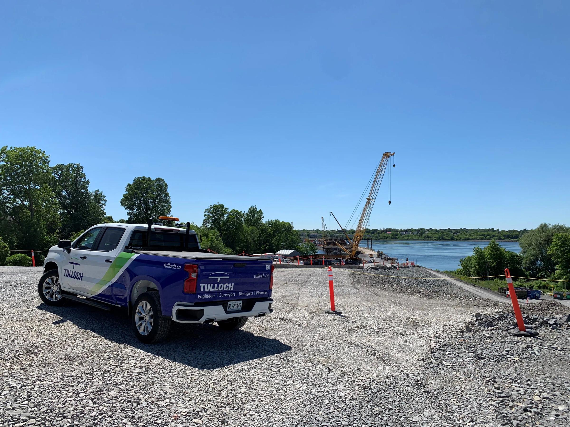 TULLOCH company truck parked at a waterfront project site.